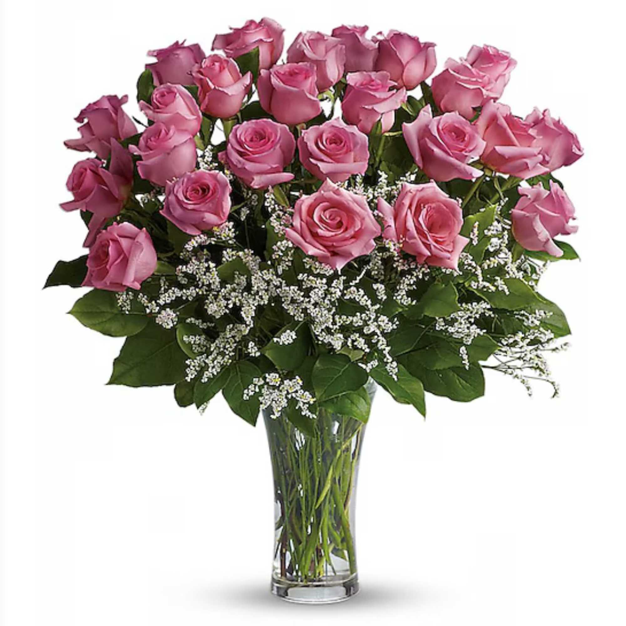 Large bouquet of pink roses with white filler flowers in a tall clear glass vase