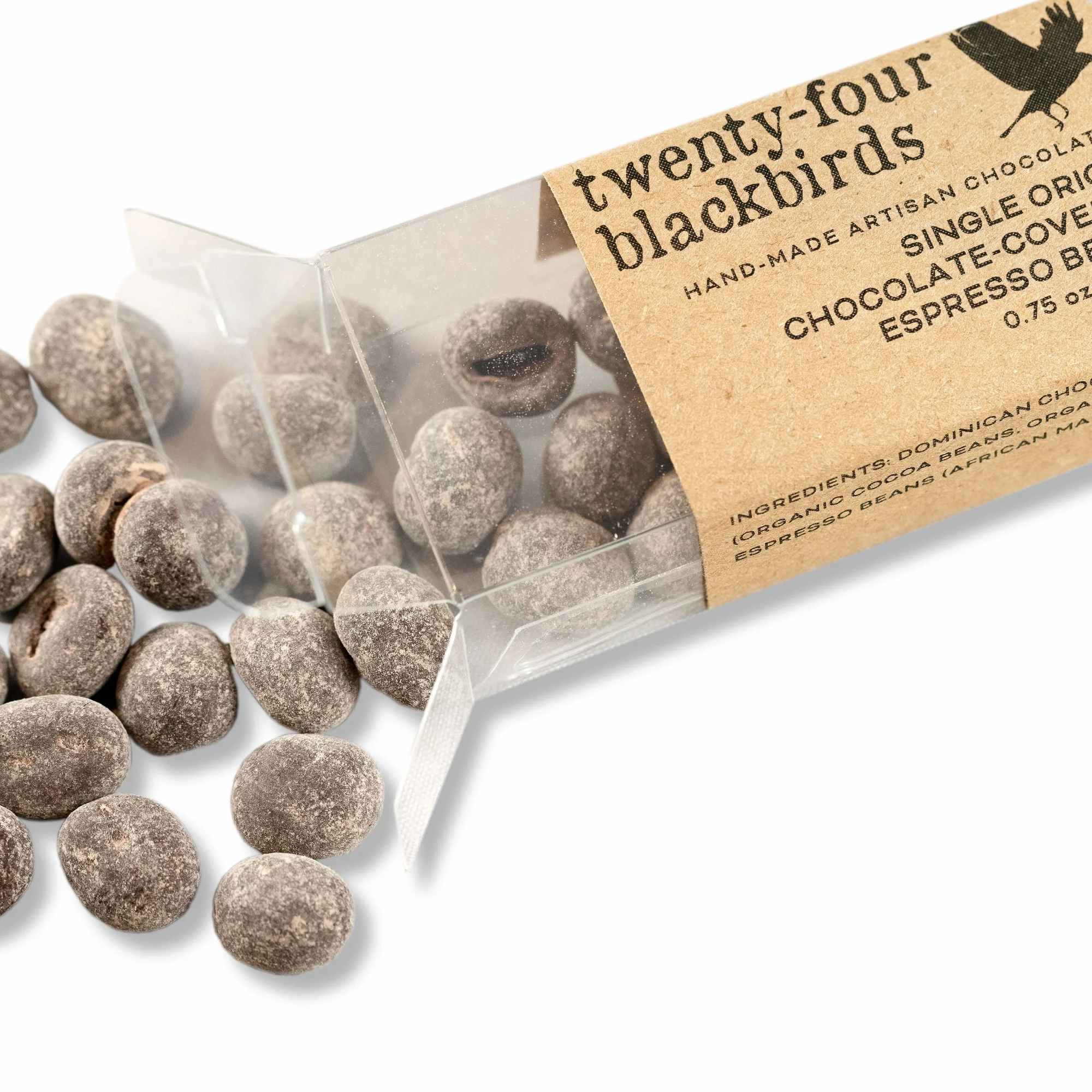 Box of chocolate-covered espresso beans spilled onto a white surface