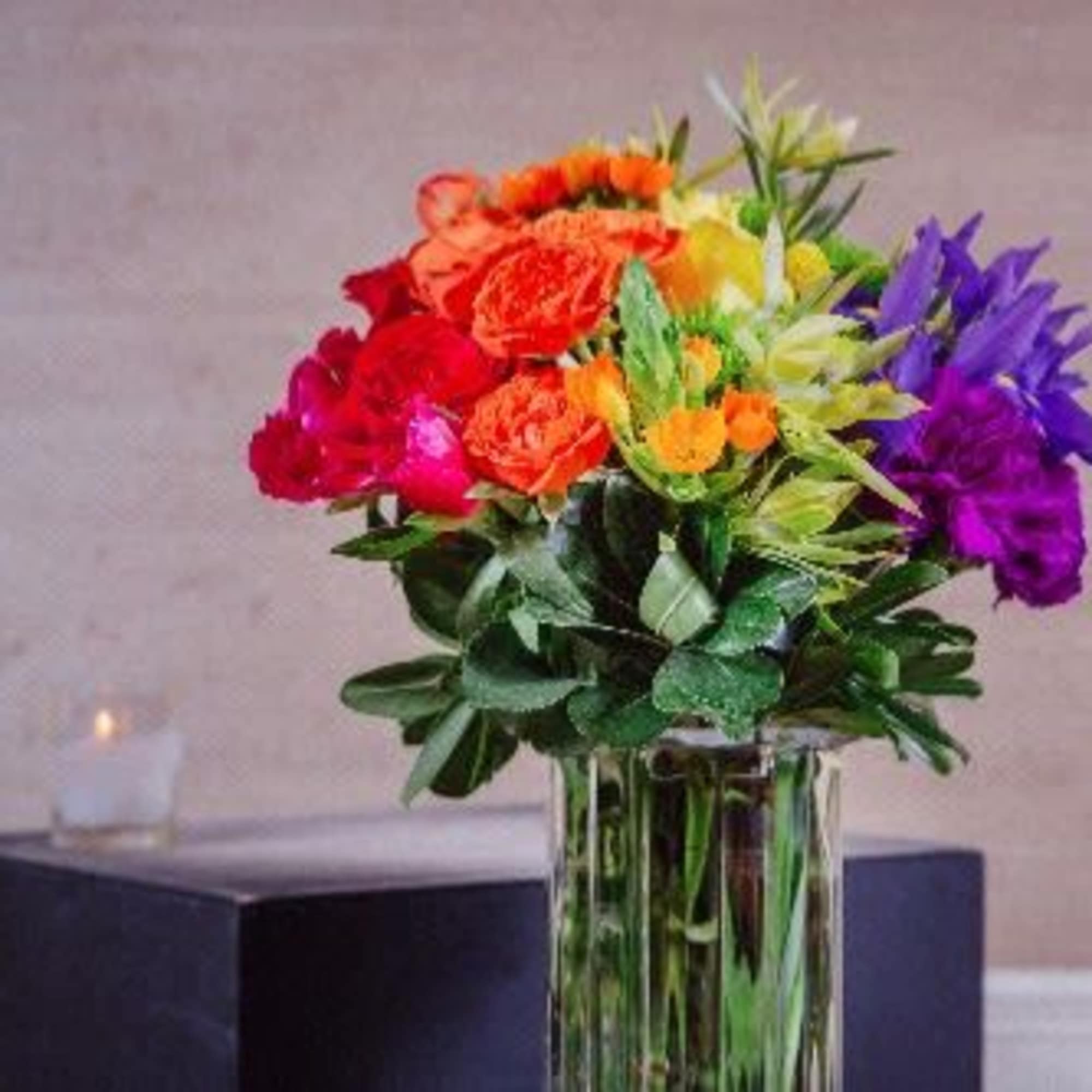 Colorful bouquet of mixed flowers in a clear glass vase
