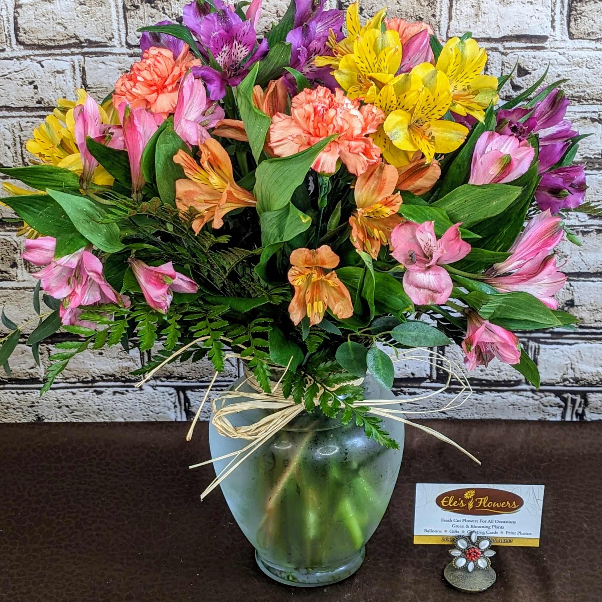 Colorful bouquet of alstroemeria in a frosted glass vase