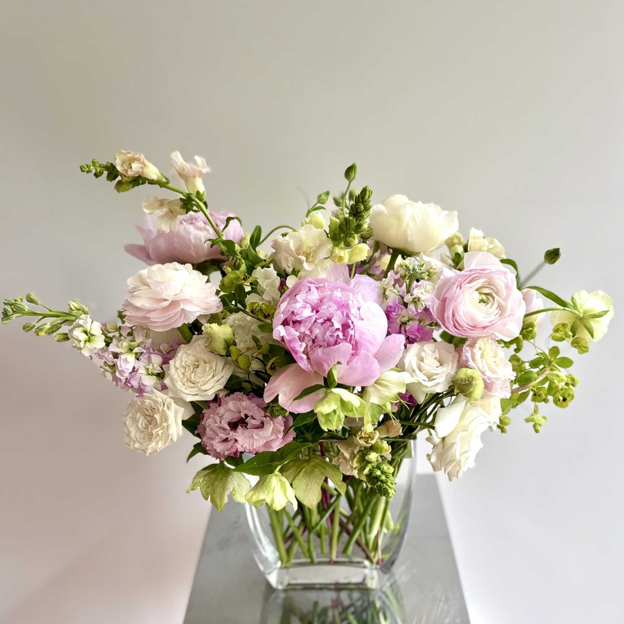 A lovely spring flower arrangement in soft blush pinks and whites. The