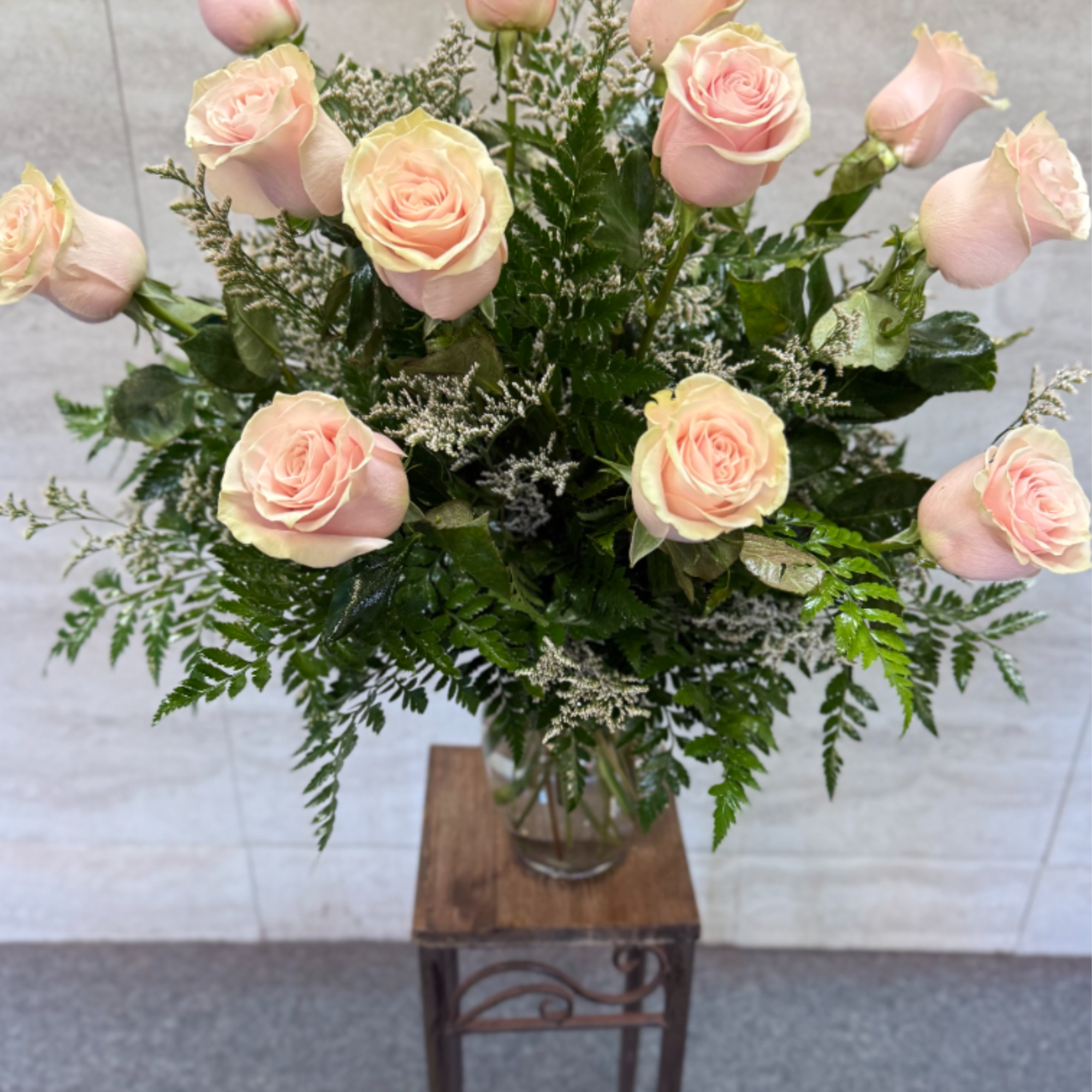 (ALL-ROUND) Soft pale pink roses with white filler and dark greenery in