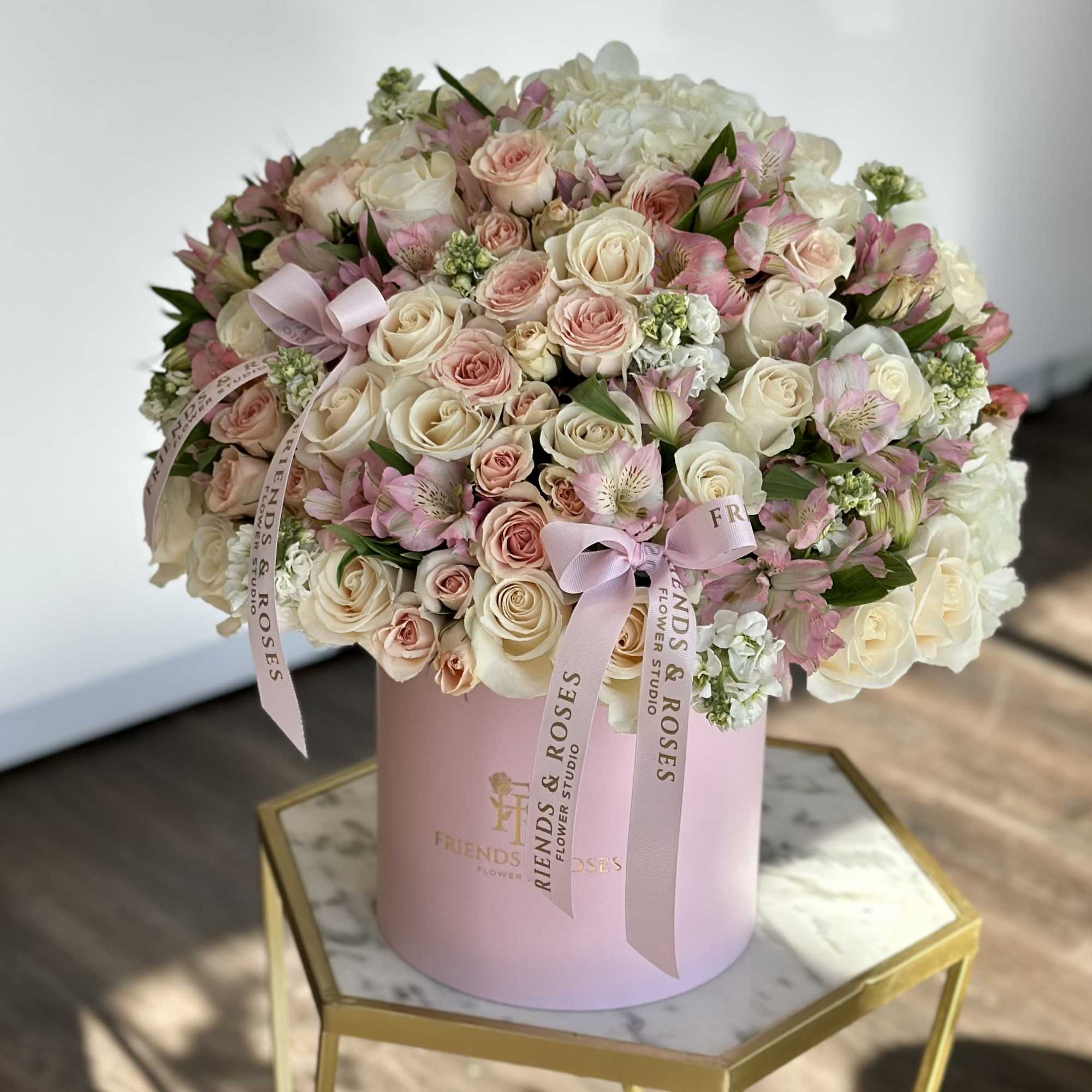 Pink and white rose bouquet in a pastel pink hat box with ribbons