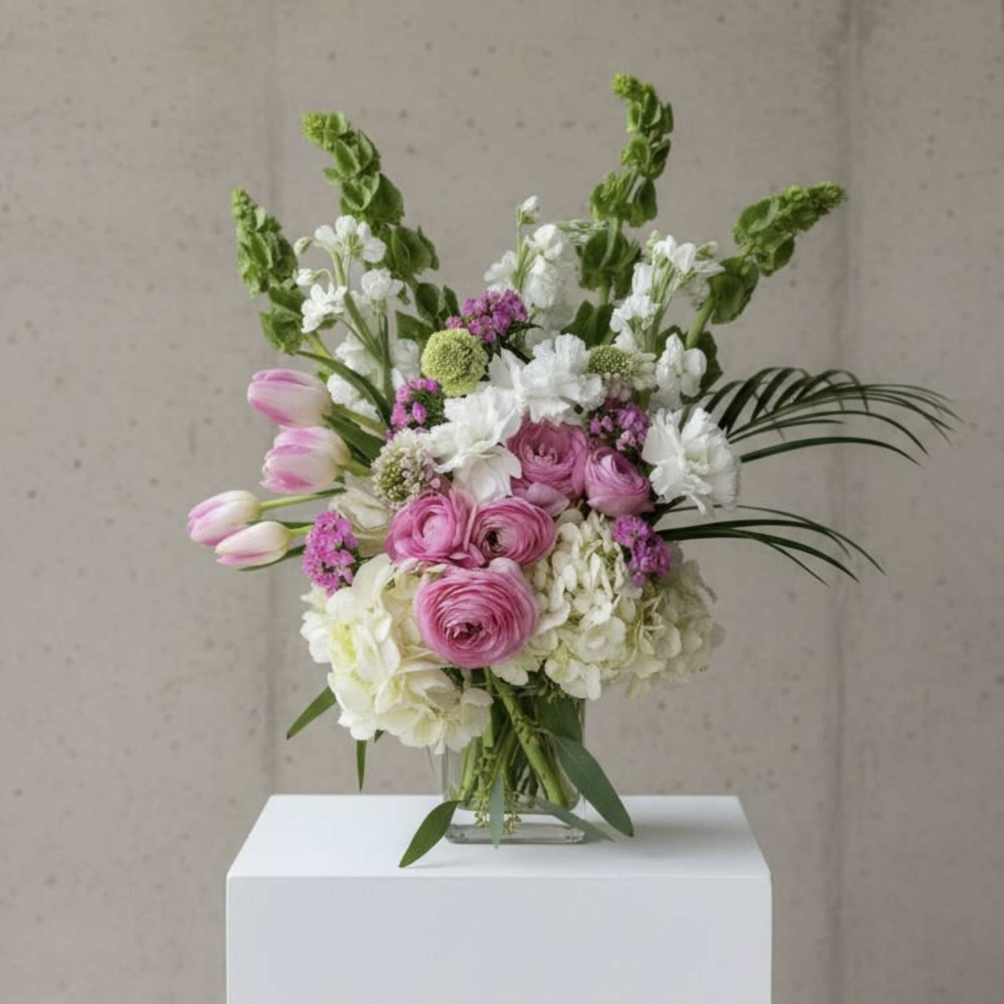 Pink and white mixed bouquet in a clear glass vase