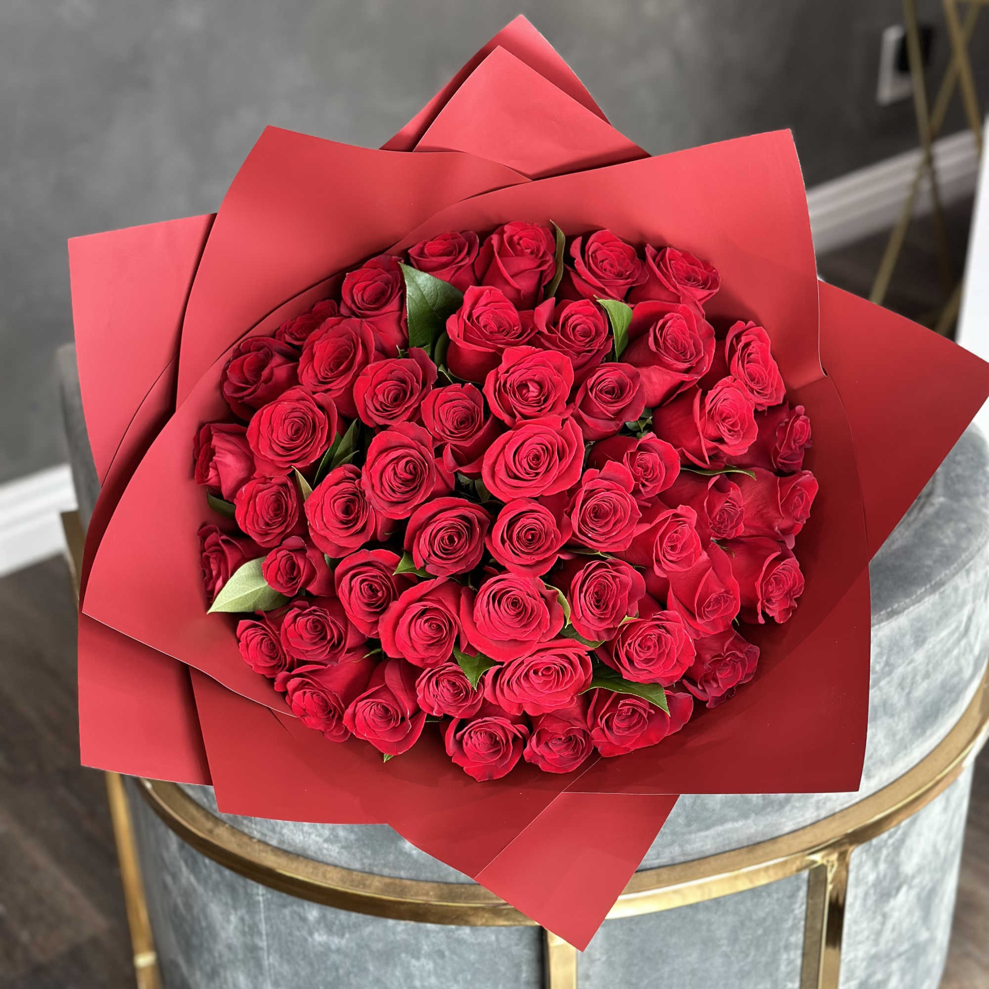 Bouquet of red roses wrapped in red paper