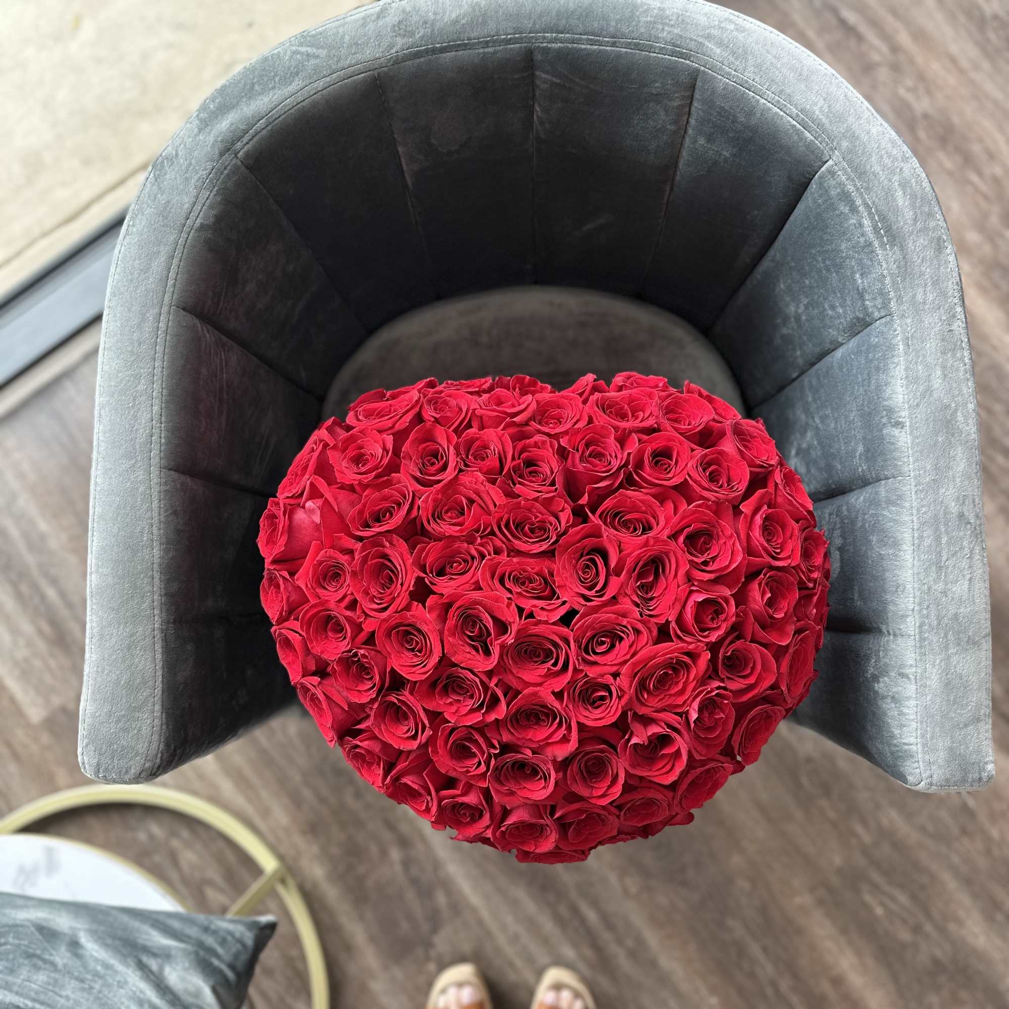Heart-shaped bouquet of red roses in a gray chair