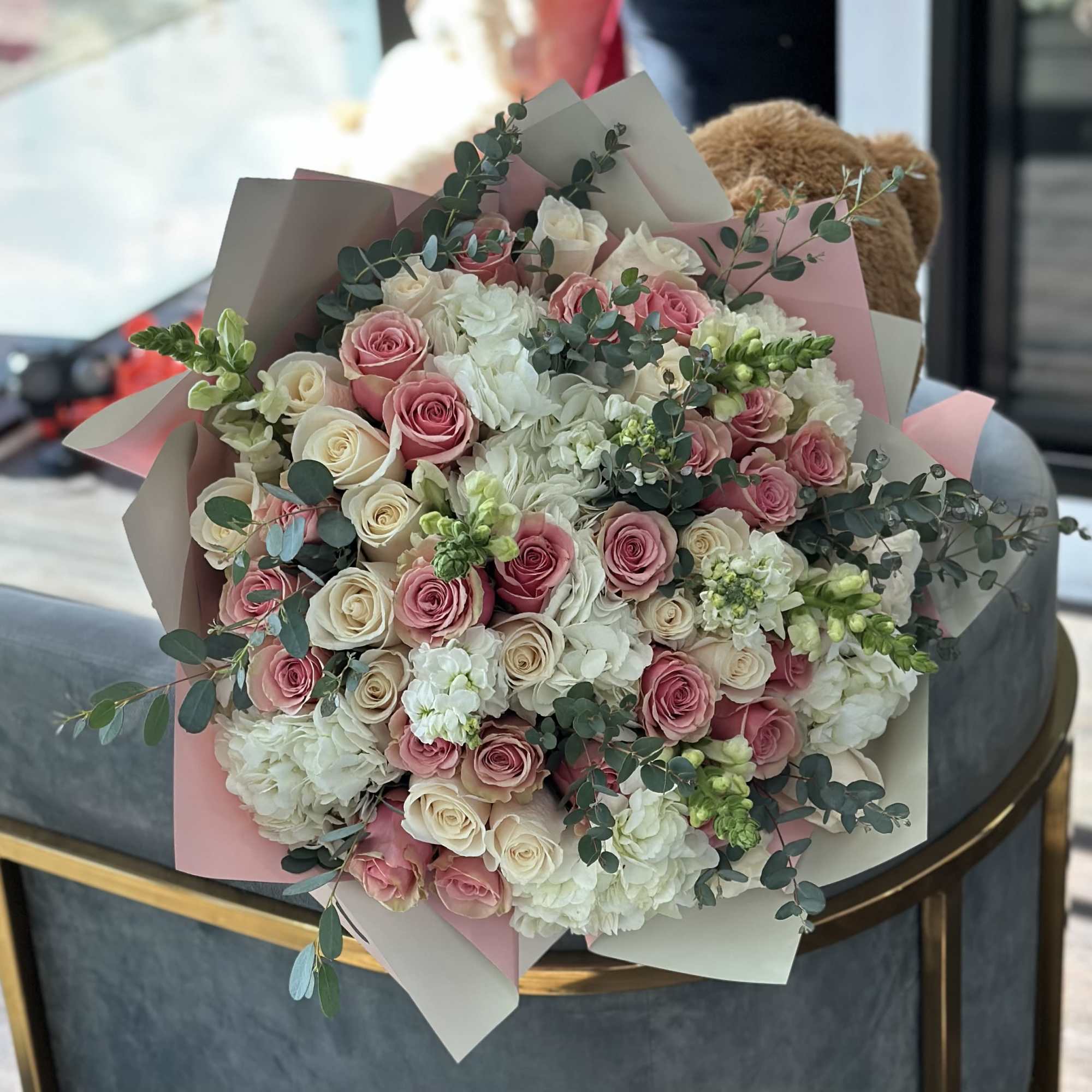 Large bouquet of pink and white roses with white blooms and eucalyptus