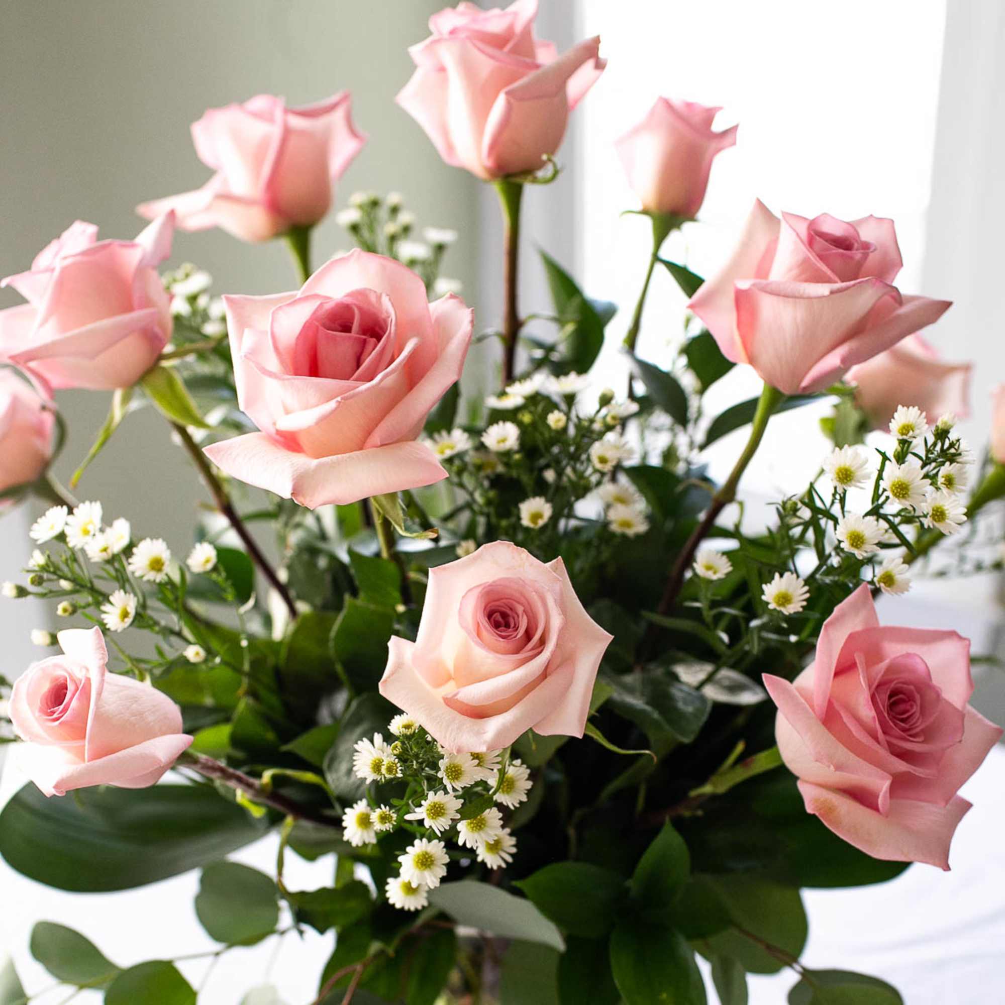 Bouquet of pink roses with small white filler flowers