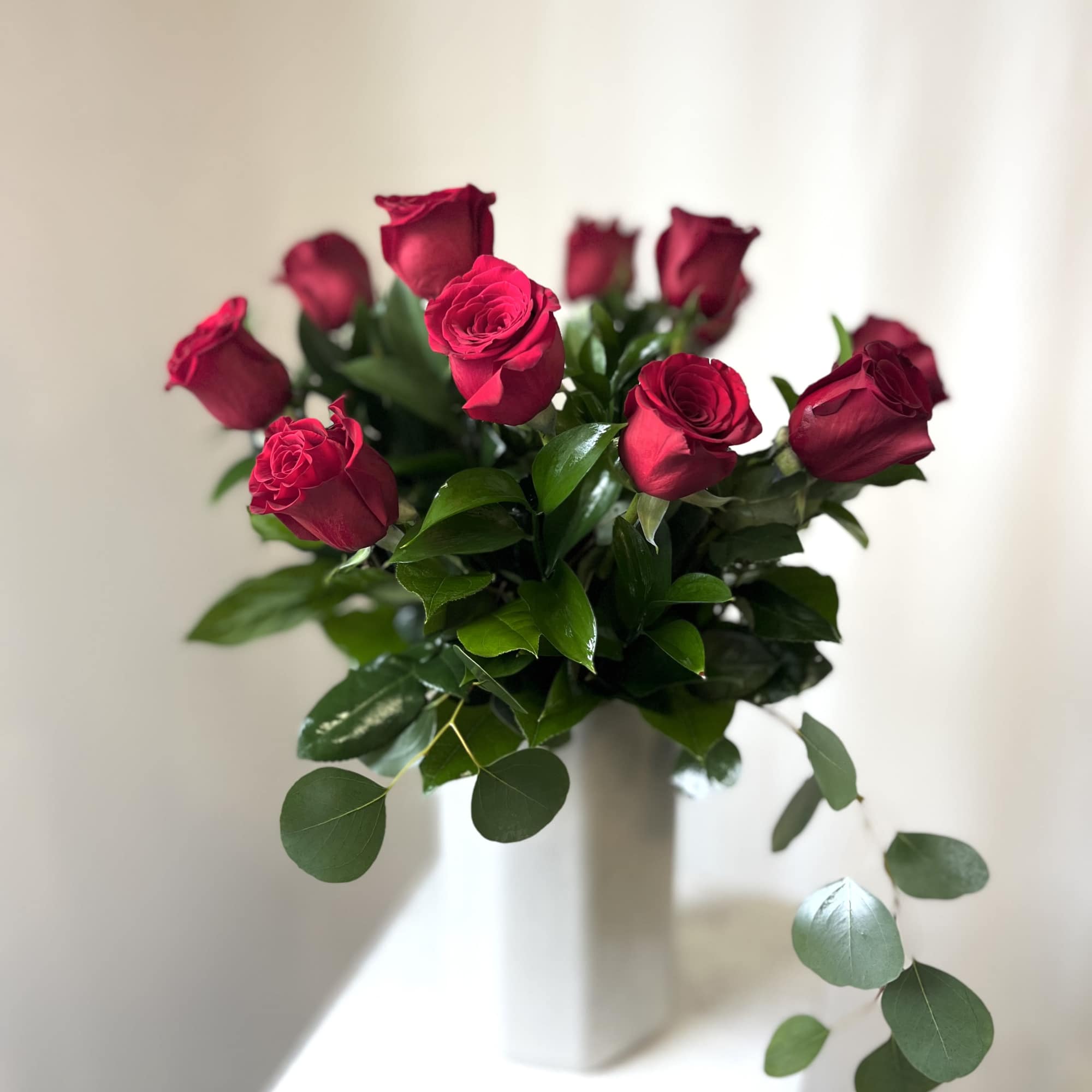 Bouquet of red roses in a white vase