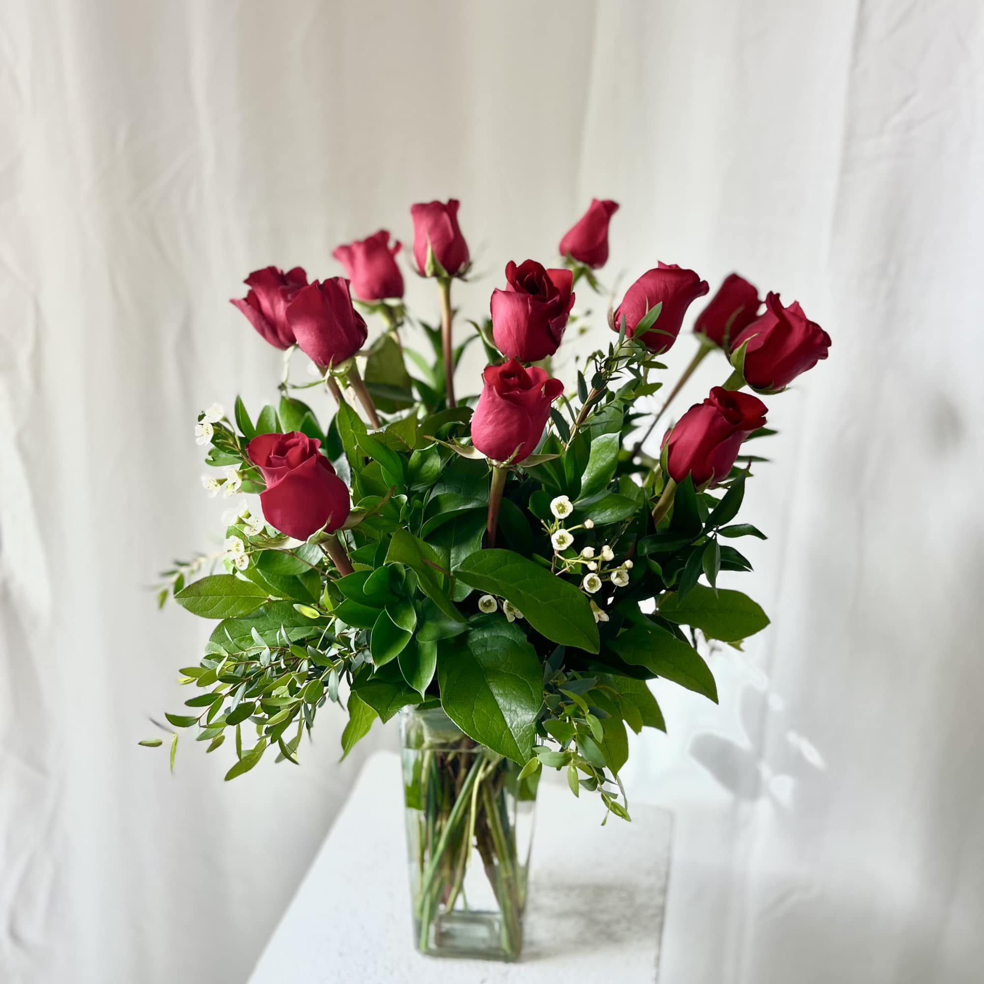 Bouquet of red roses in a clear glass vase