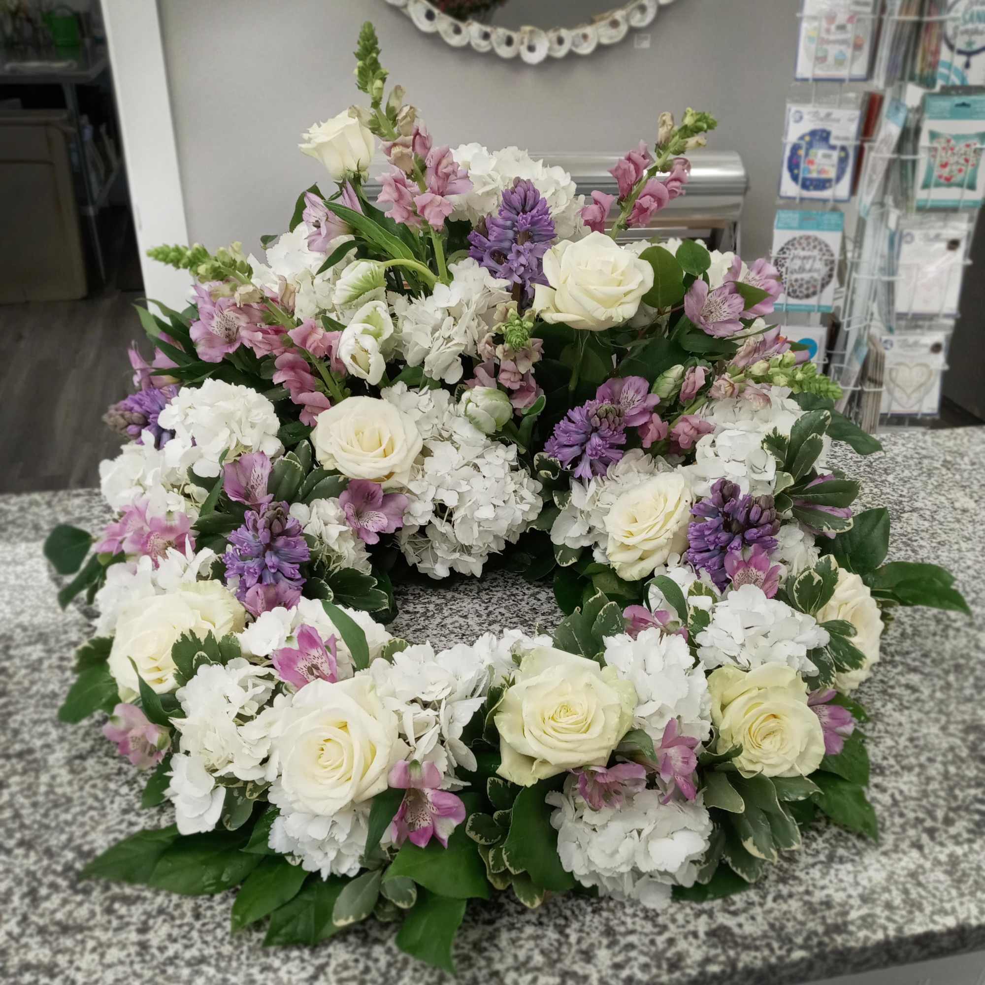 This arrangement surrounds the urn of your loved one with beautiful seasonal