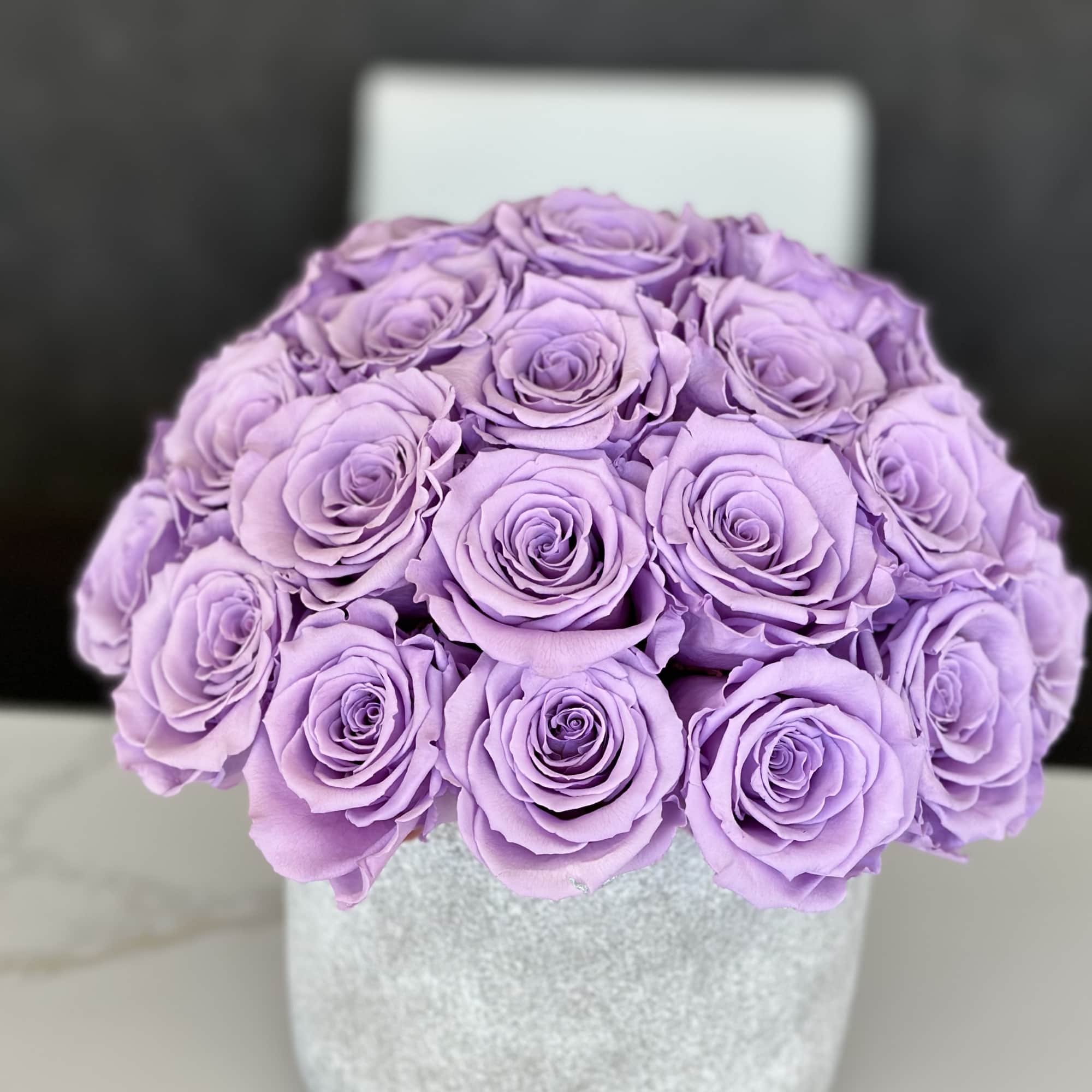 Lavender rose bouquet in a silver round box