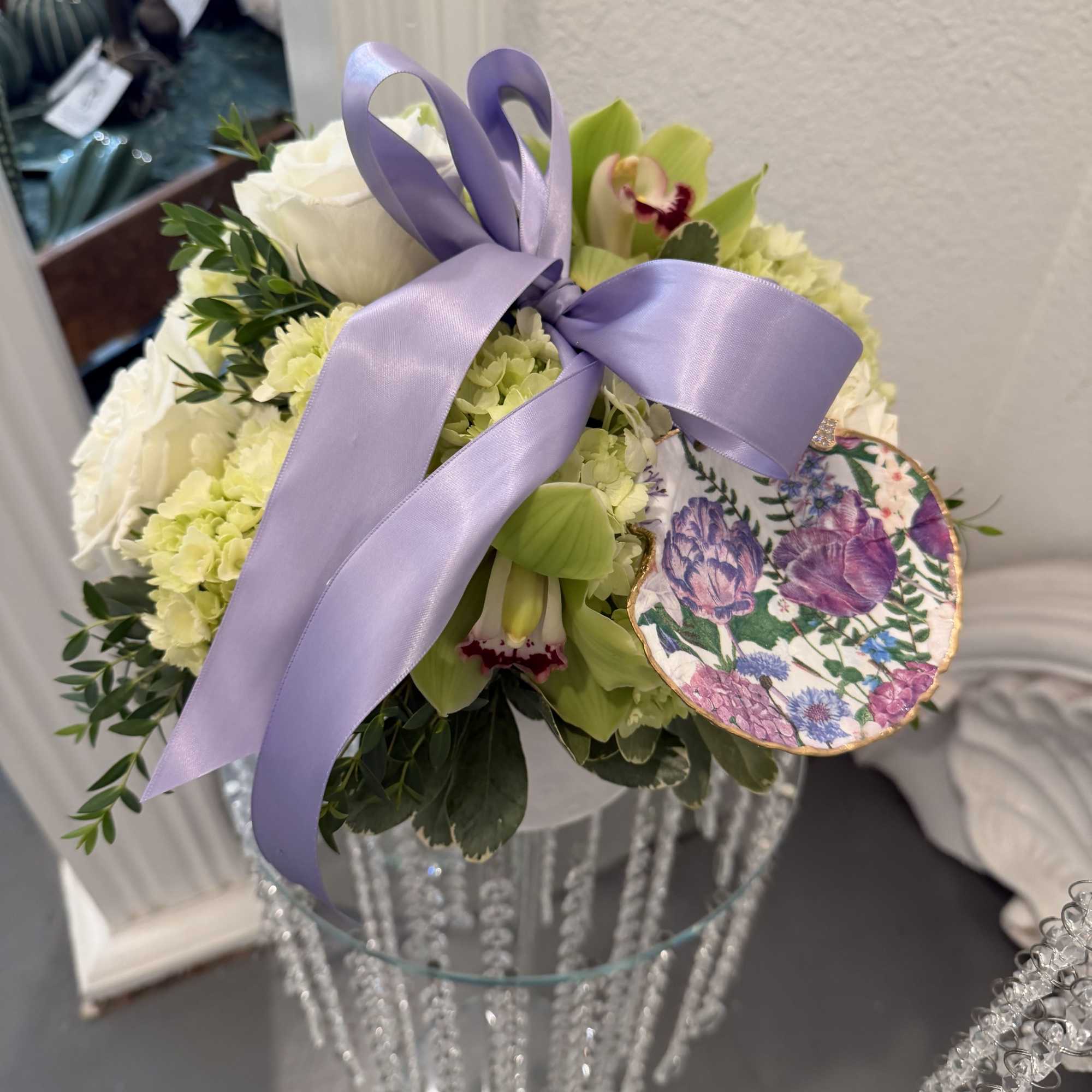 Soft whites and pale green florals take center stage in this In