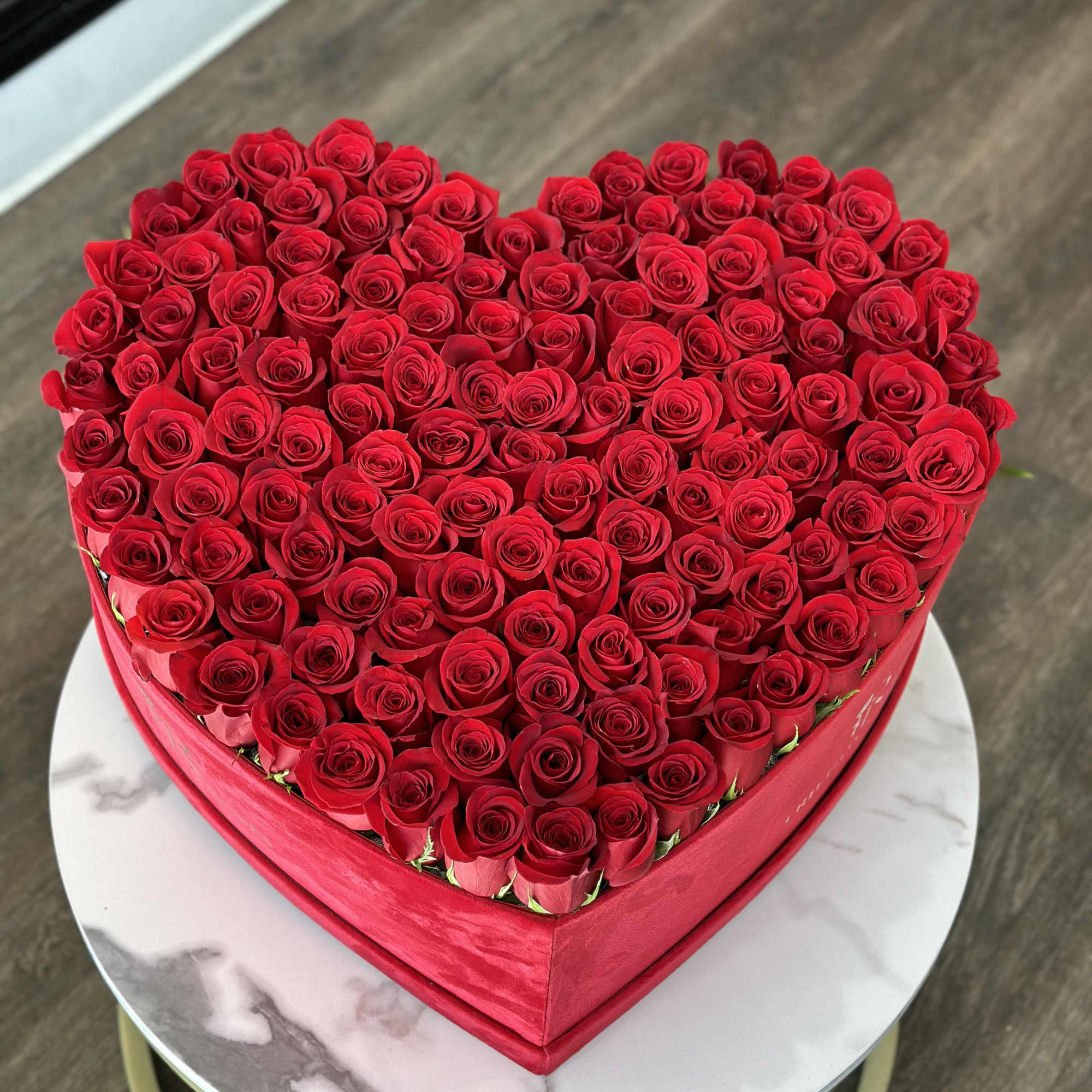 Heart-shaped box filled with red roses
