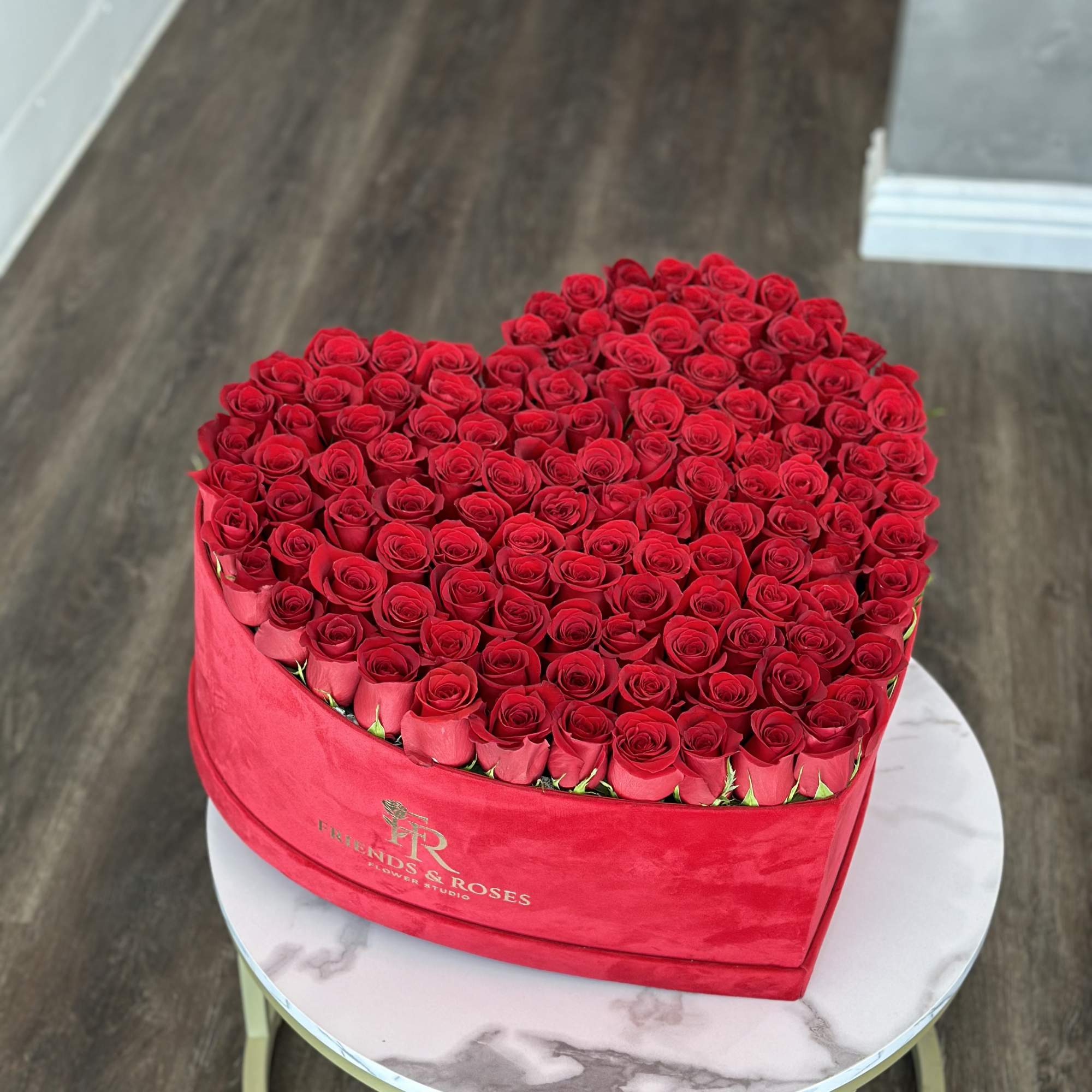 Heart-shaped box filled with red roses
