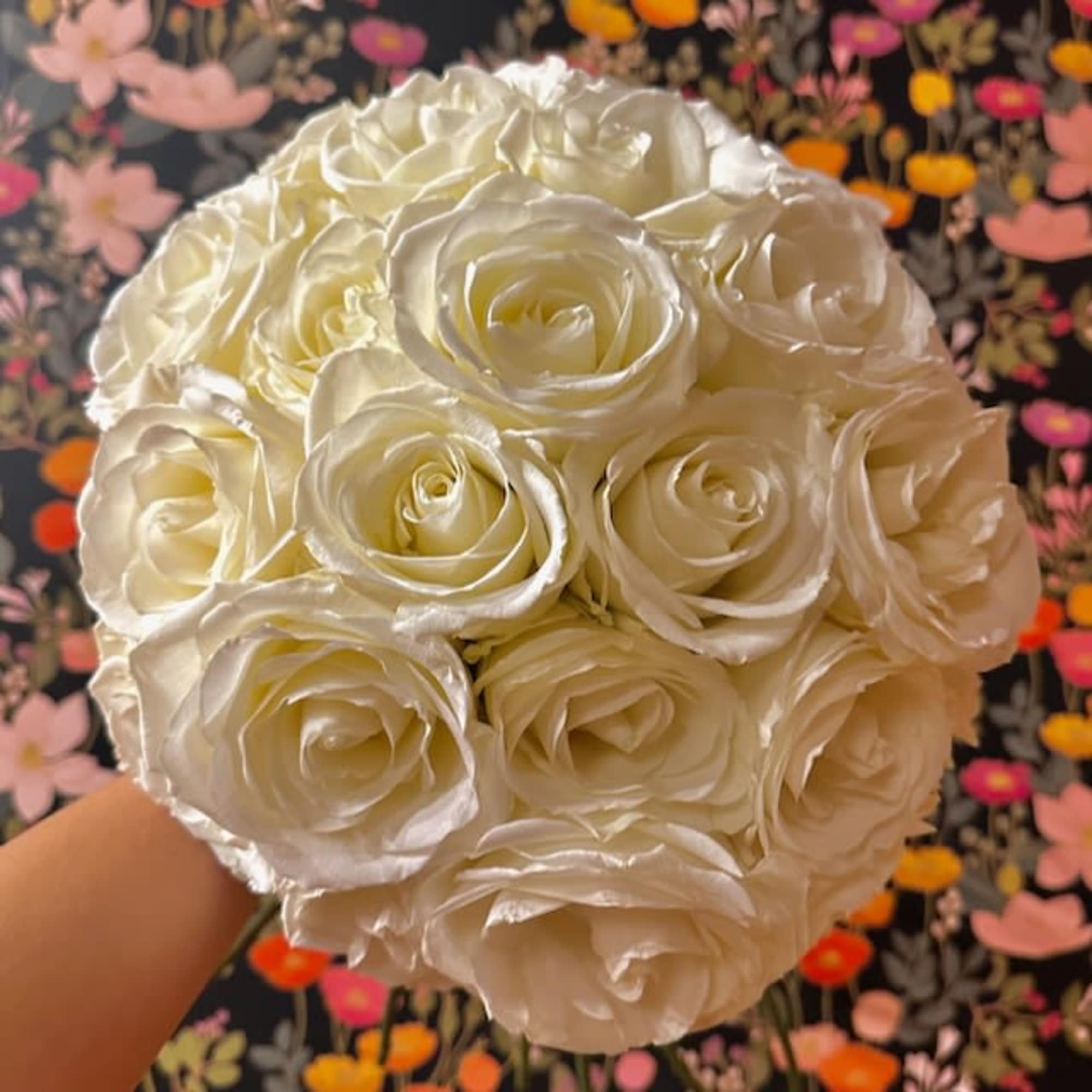 Bouquet of cream-white roses held in hand