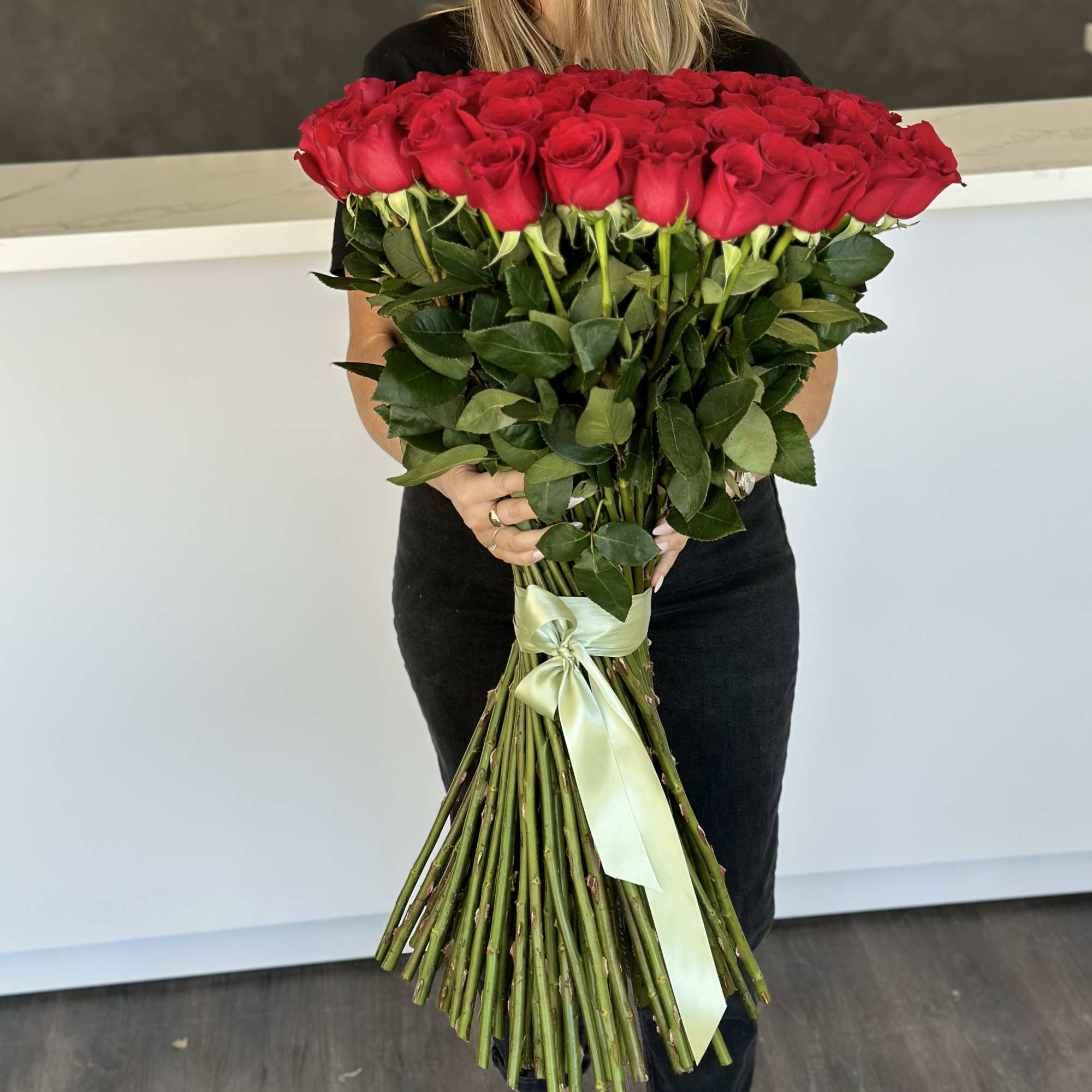 Large bouquet of red roses tied with a pale ribbon