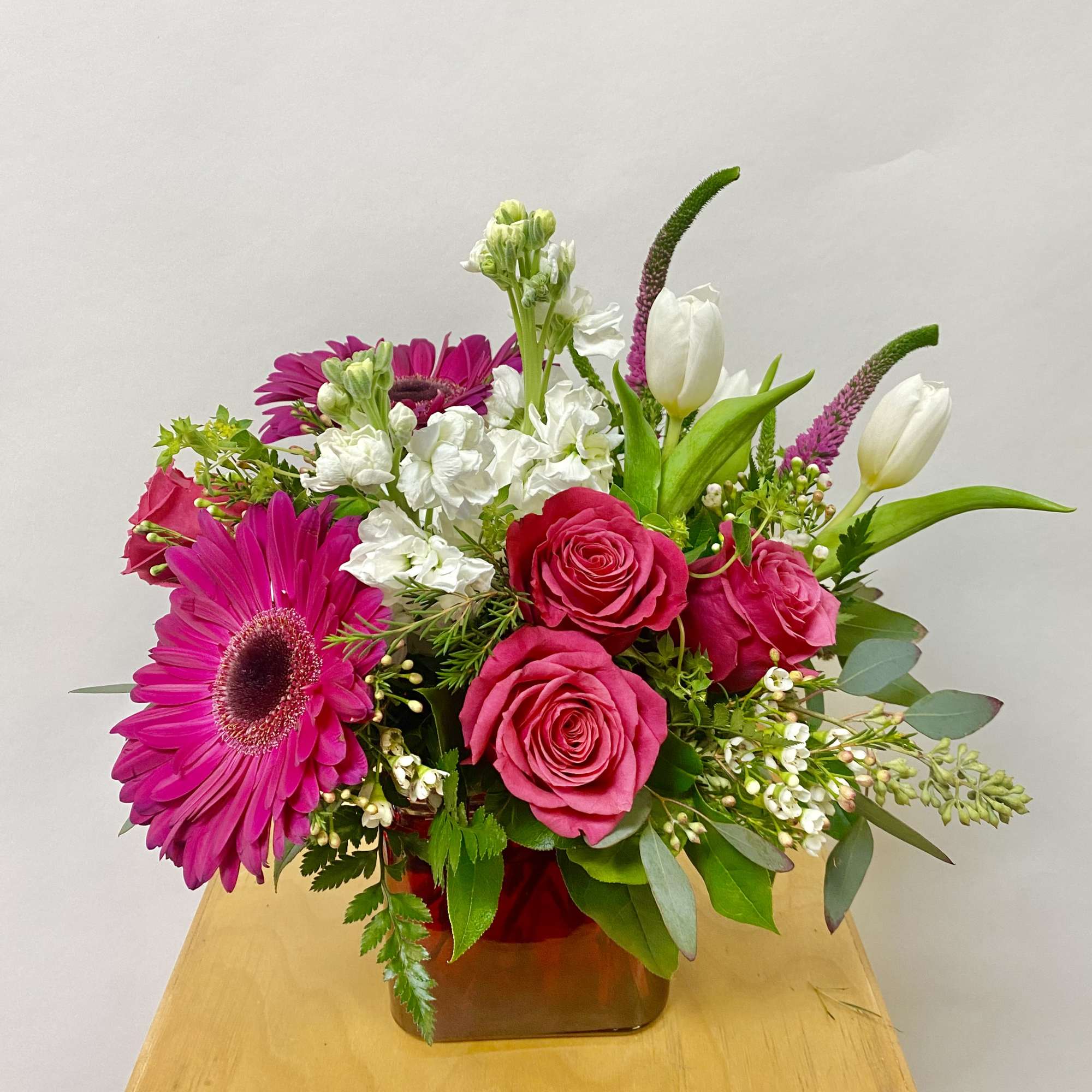 Pink and white mixed bouquet in a square glass vase