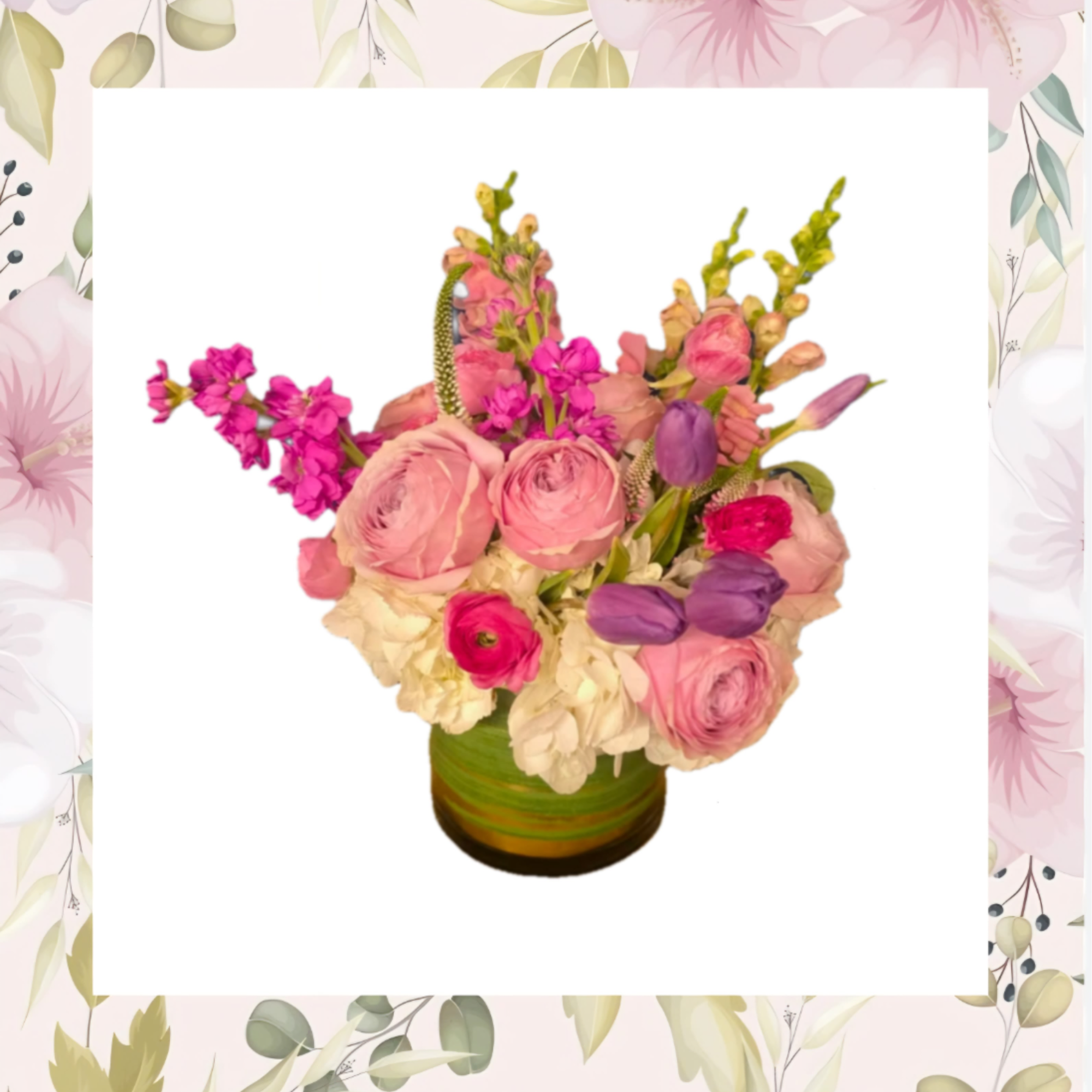 Pink and purple mixed flower arrangement in a green vase