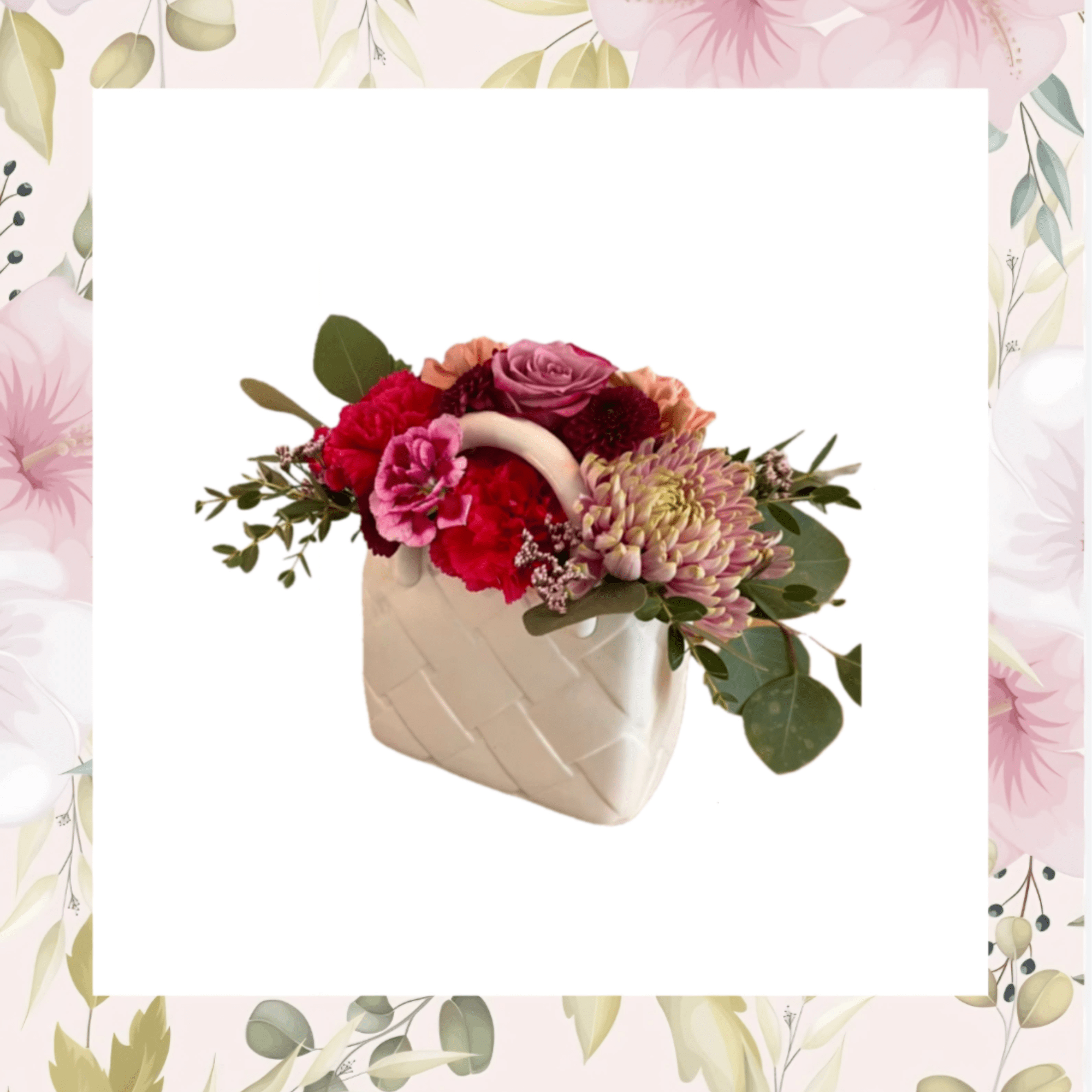 Pink and red flower arrangement in a white ceramic vase