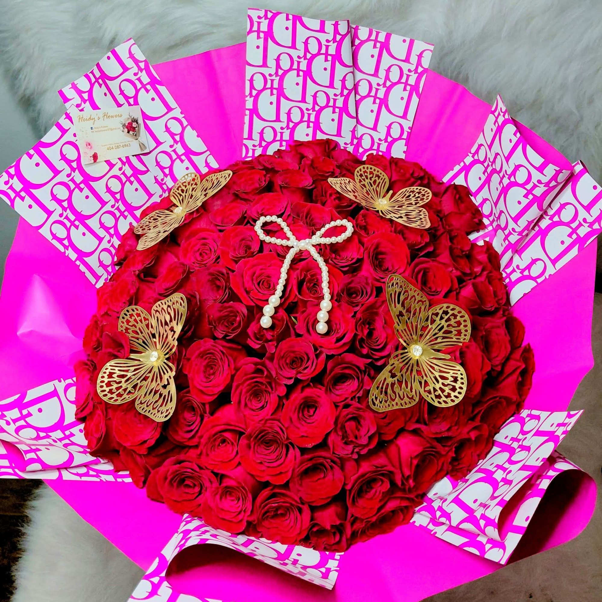 100 beautiful red rouses. Wrapped  with butterflies  snd dior paper.