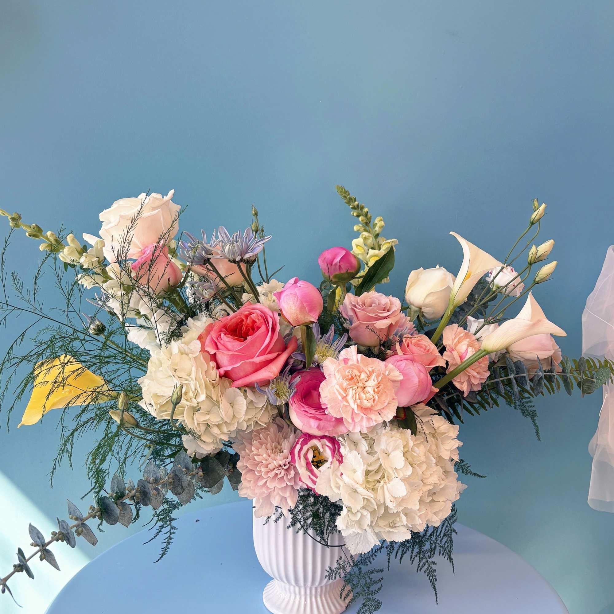 Pink and white mixed bouquet in a white vase