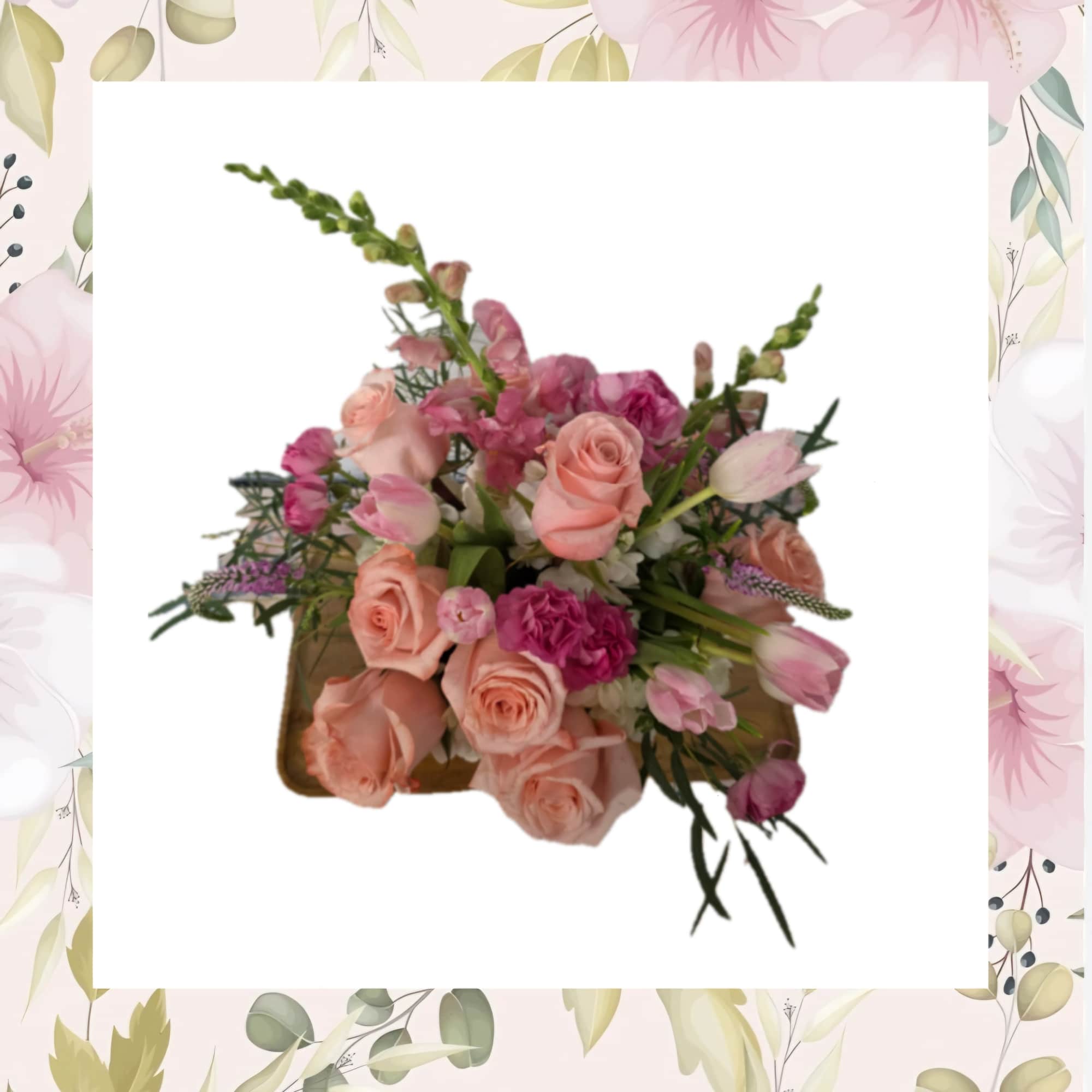 Soft blush roses and pink tulips mingle with peach ranunculus and airy