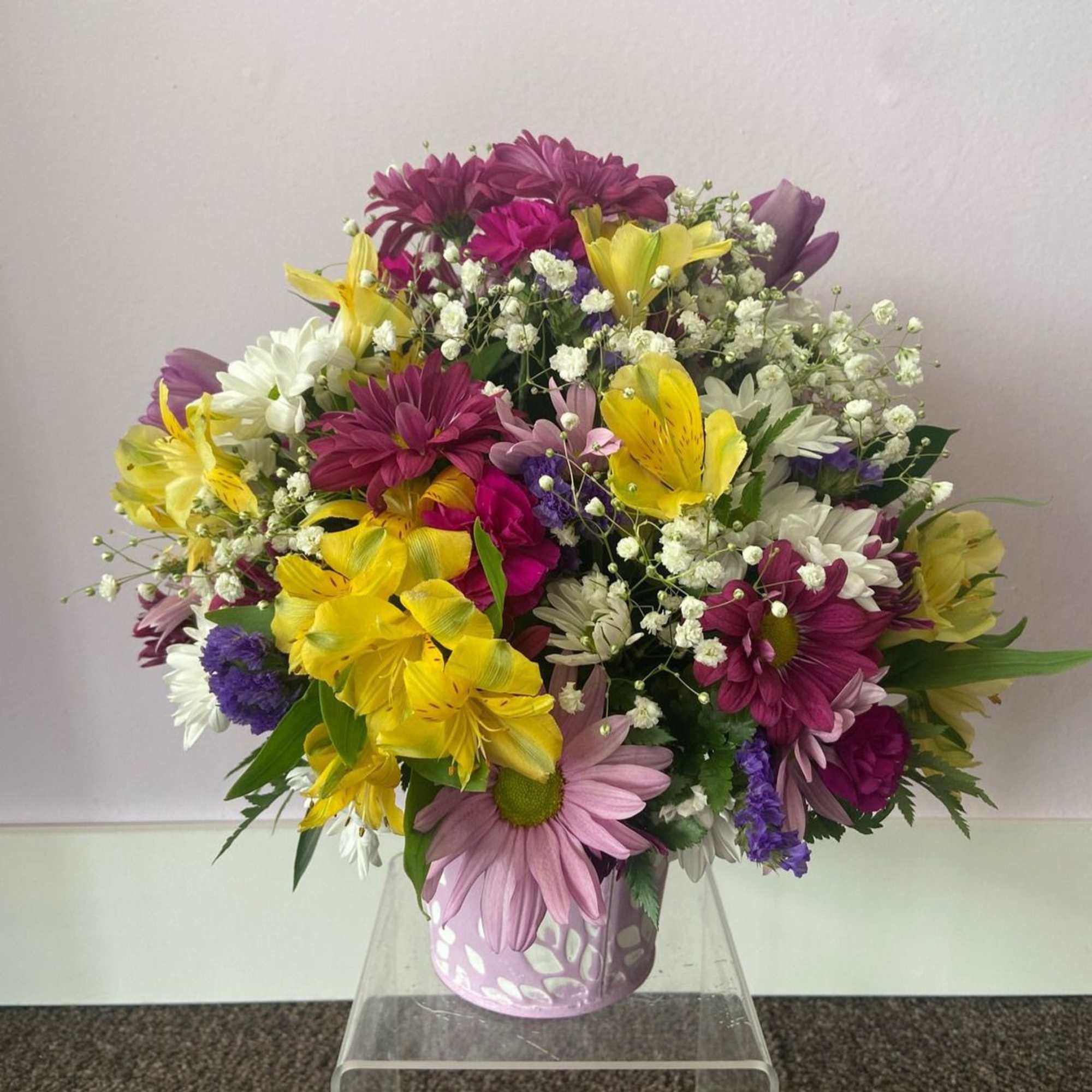 This beautiful pastel pail is full of lovely spring blooms, any Mother