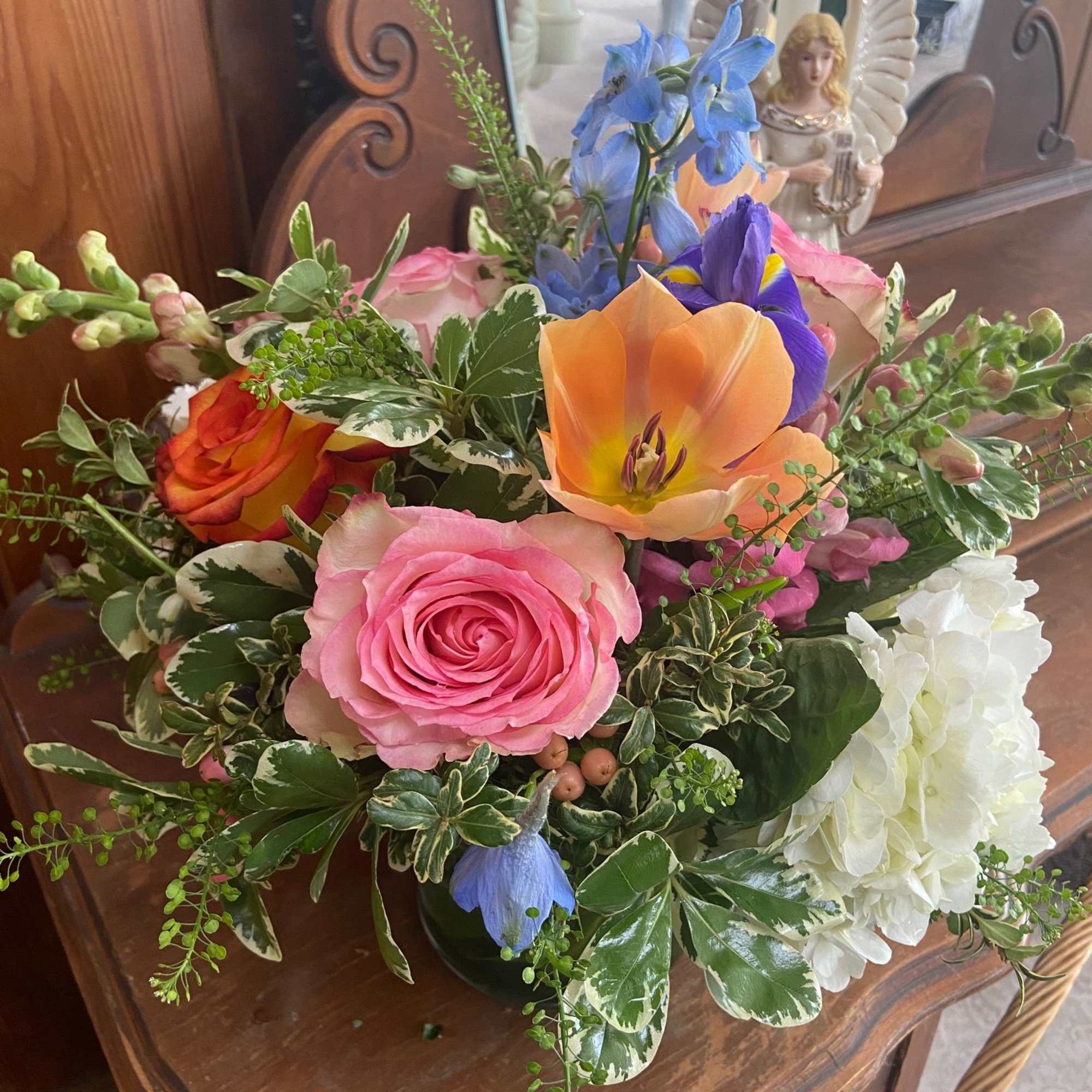 Mix of bright but feminine Spring flowers in 5 x 5 cylinder.