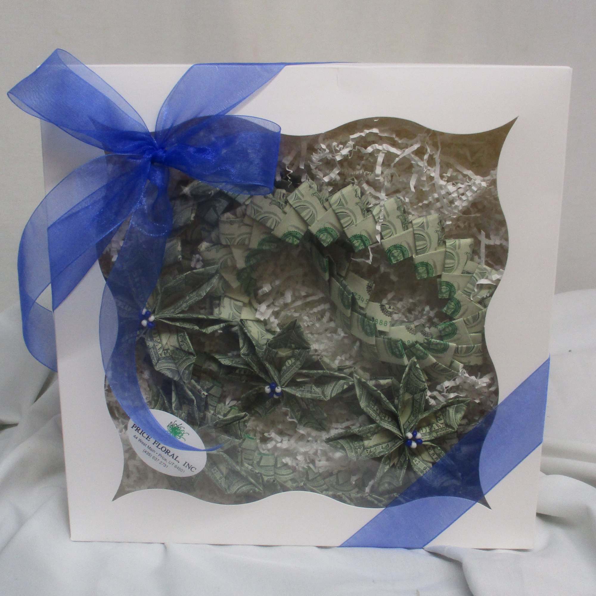 A bold, celebratory twist on a traditional gift-this green-and-white money lei turns