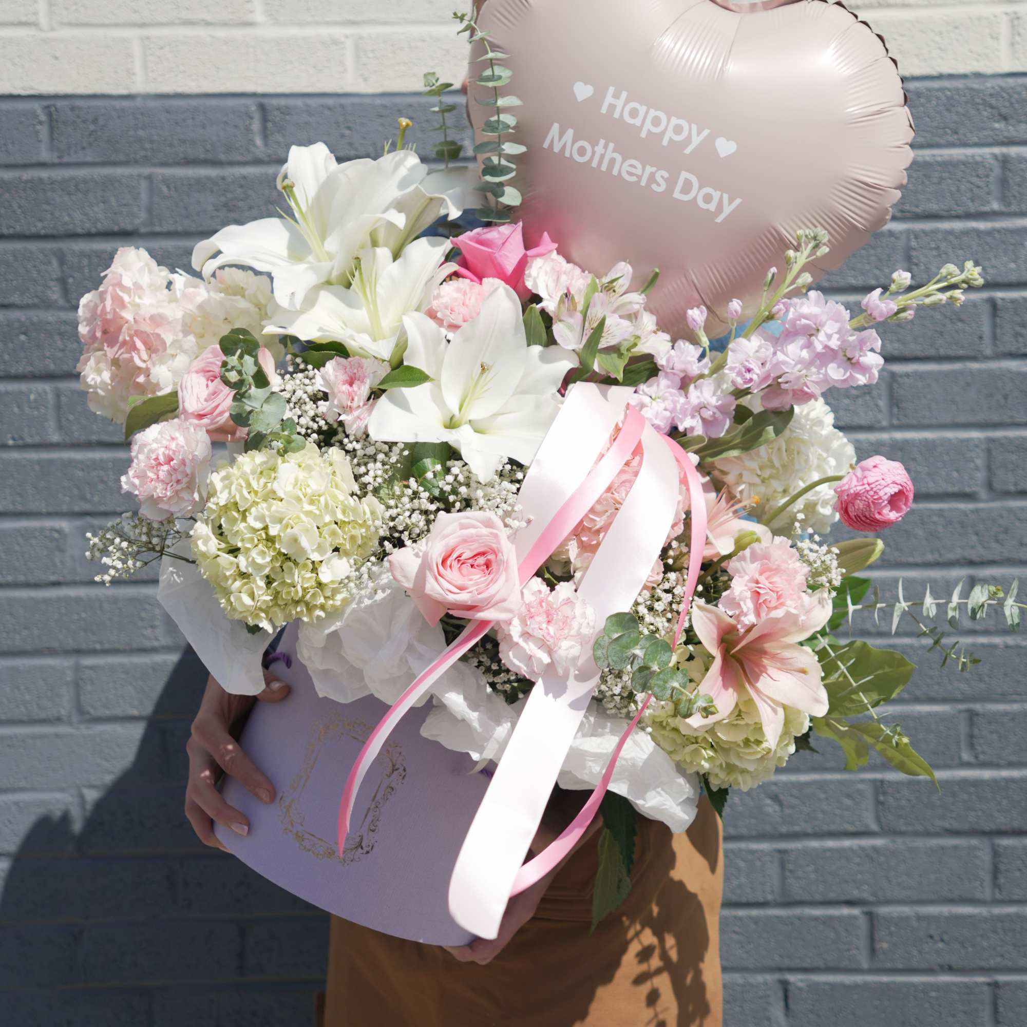 Soft blush and white lilies and roses take center stage in this