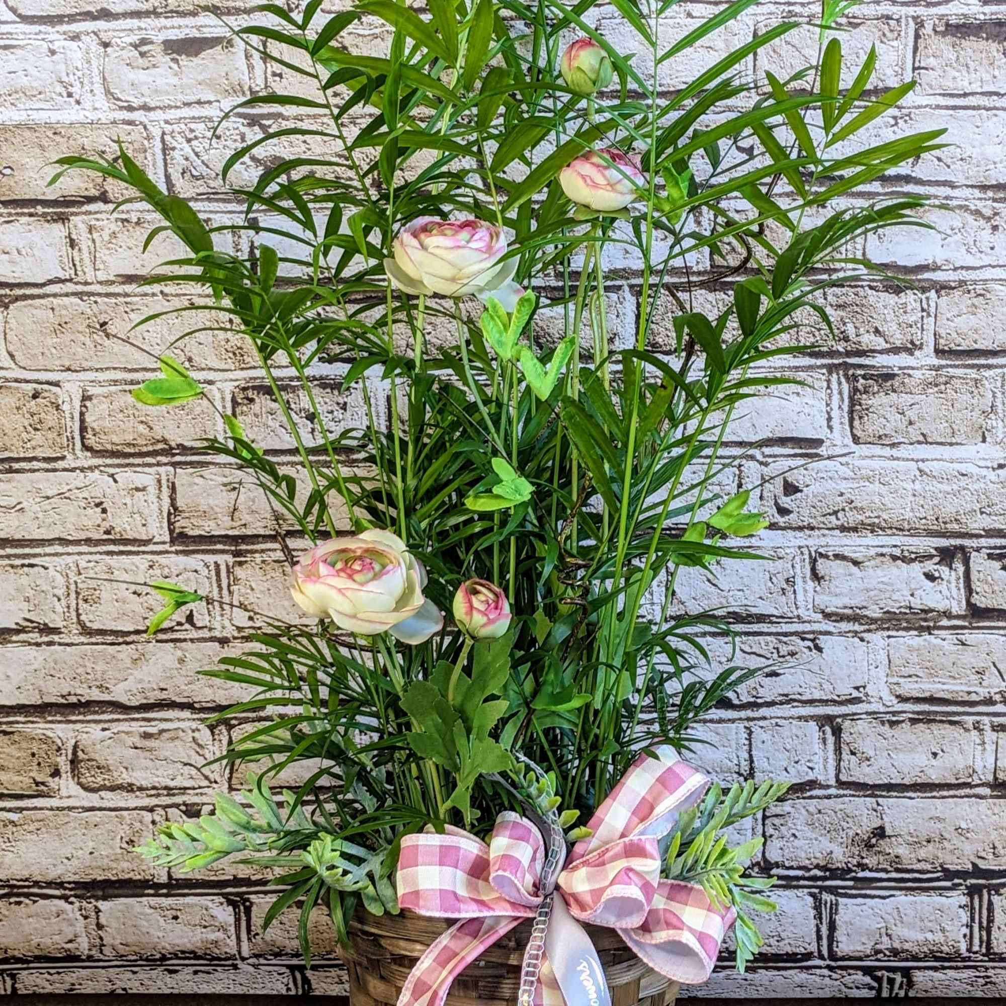 Tall potted arrangement with pale pink blooms and a pink gingham bow