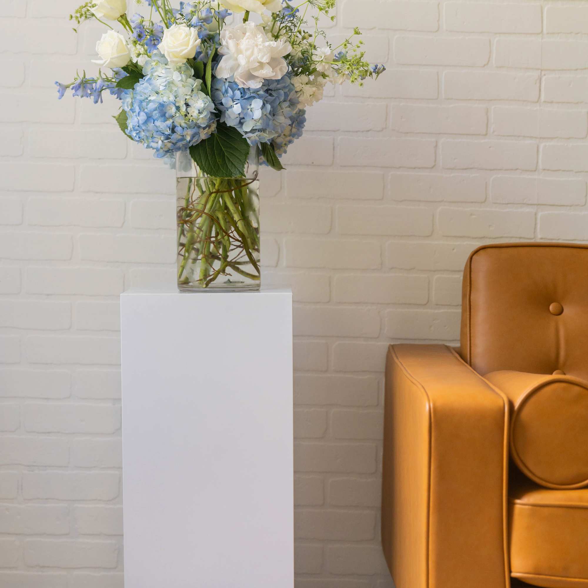 A soft, garden-inspired arrangement in calming blue and ivory tones, featuring lush