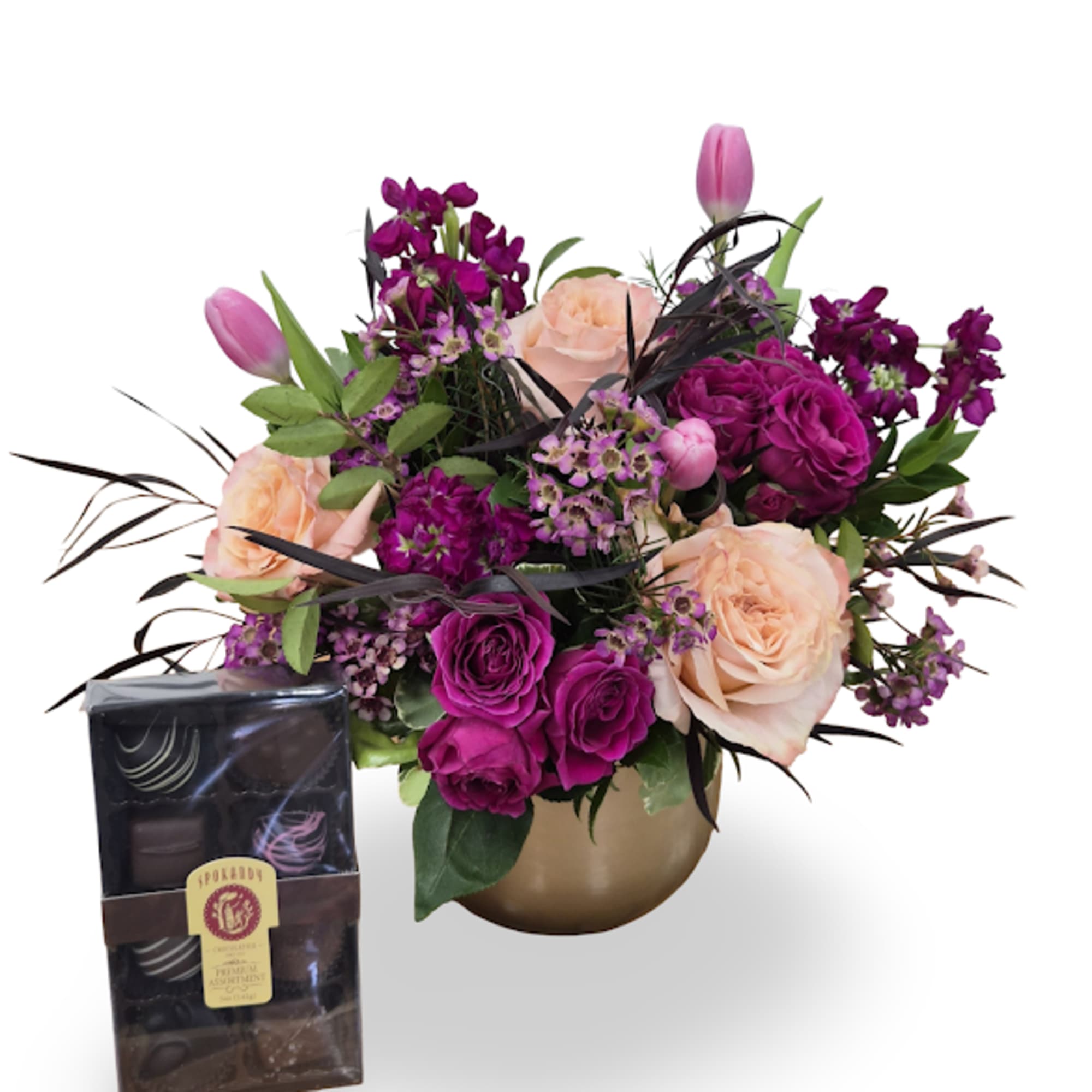 A jewel-toned celebration in a rounded gold vase-this flower arrangement blends peach