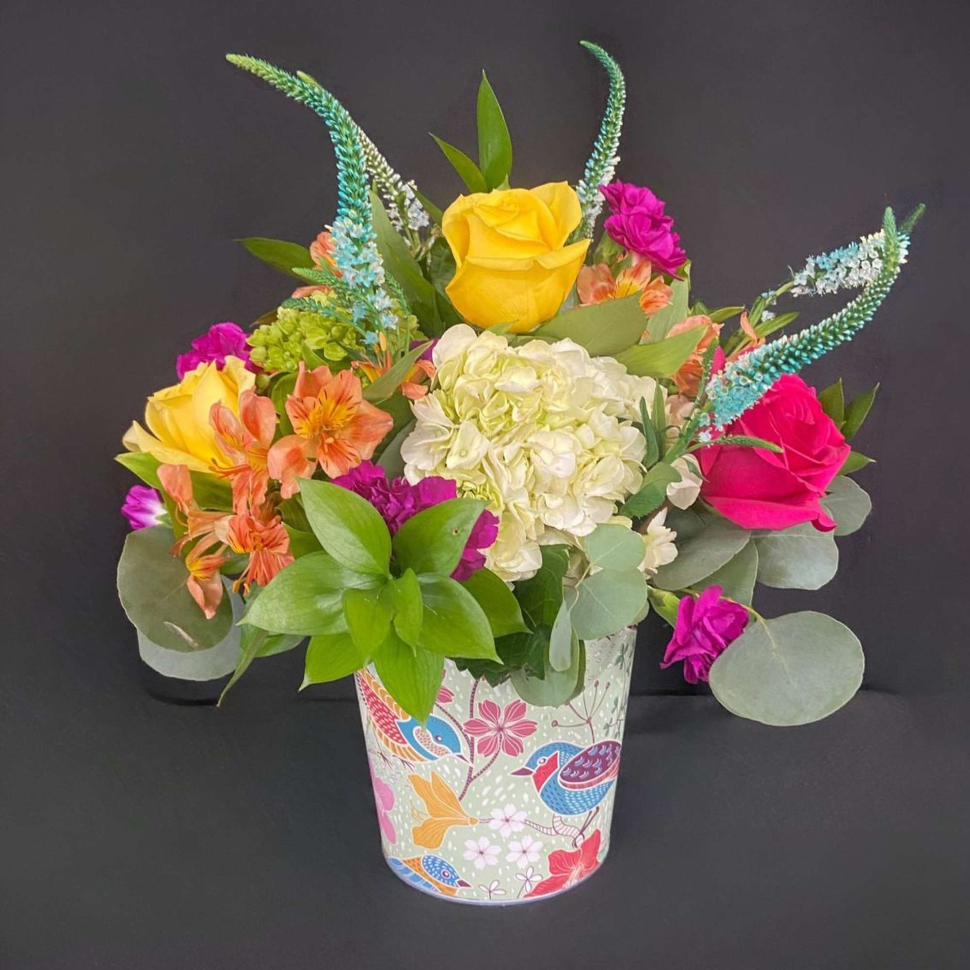 This vibrant arrangement is a cheerful garden party in a cup! It&rsquo;s