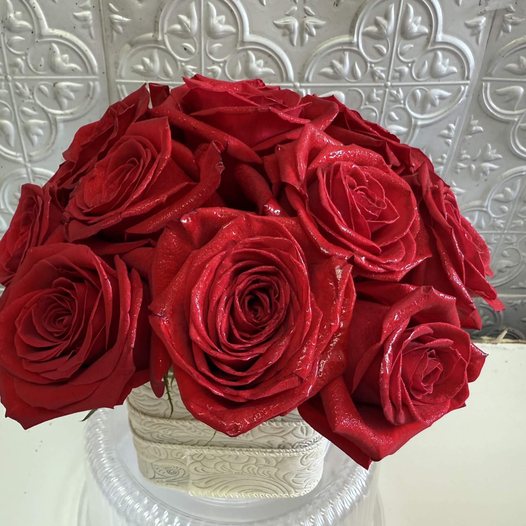 Bouquet of red roses in a white decorative vase