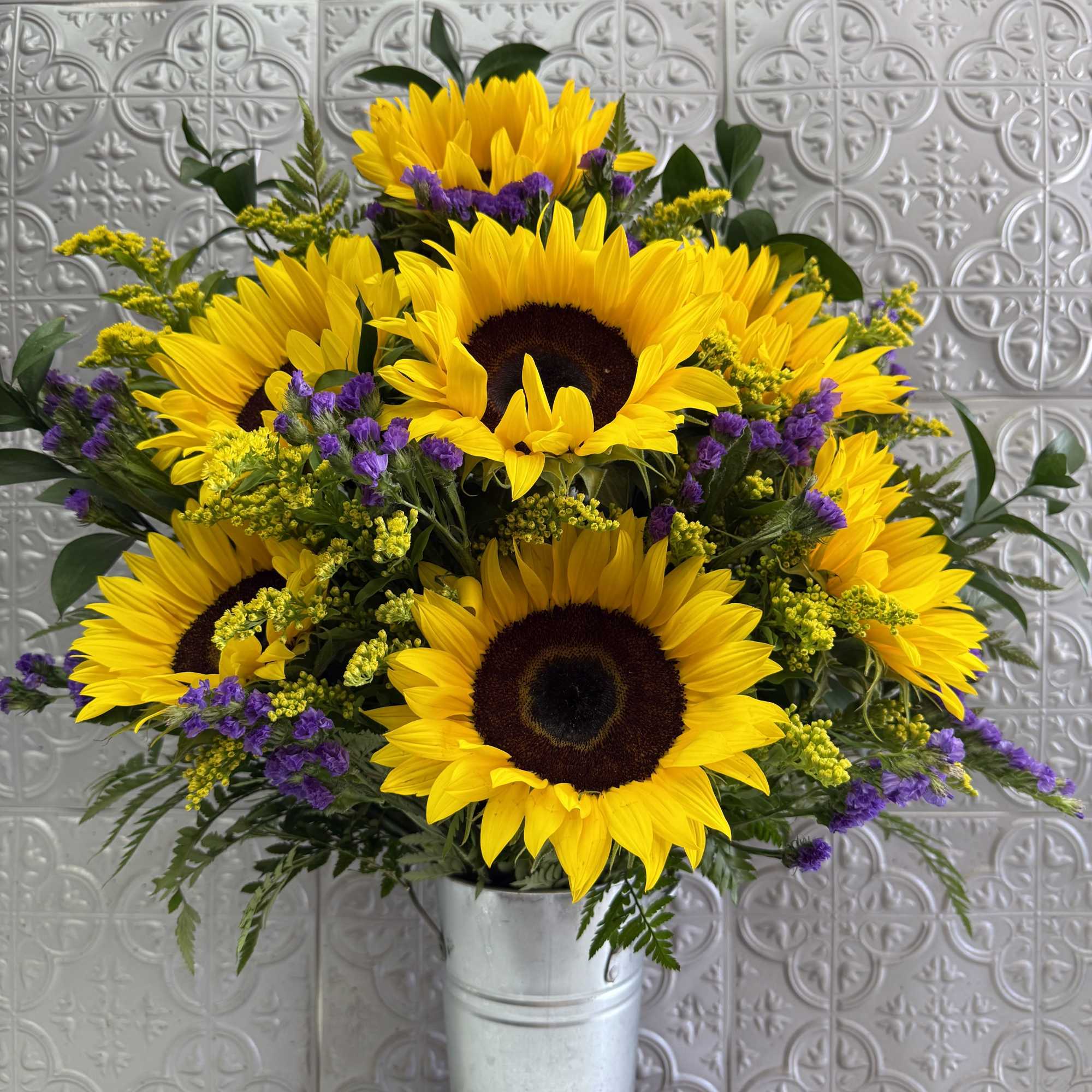 Beautiful tall floral arrangement simple but brilliant to brighten your special persons