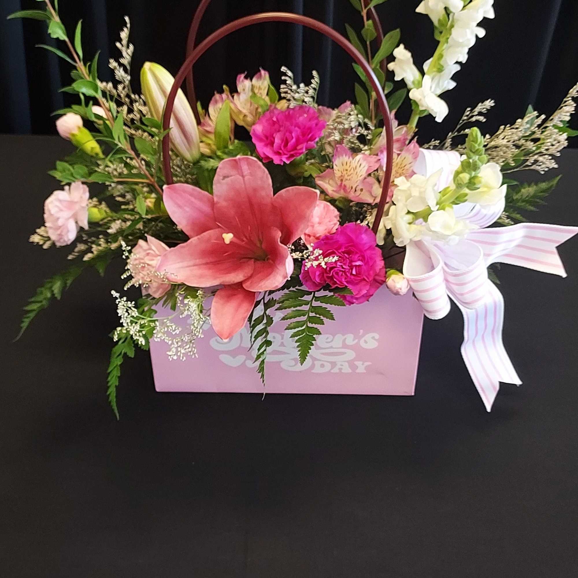 A bright pink lily takes center stage in this feminine Mother's Day