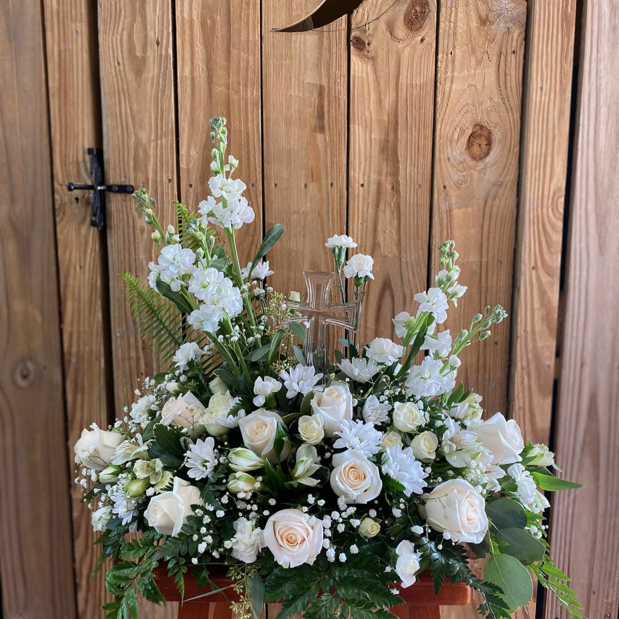 An elegant display of faith and divine peace, this beautiful arrangement will