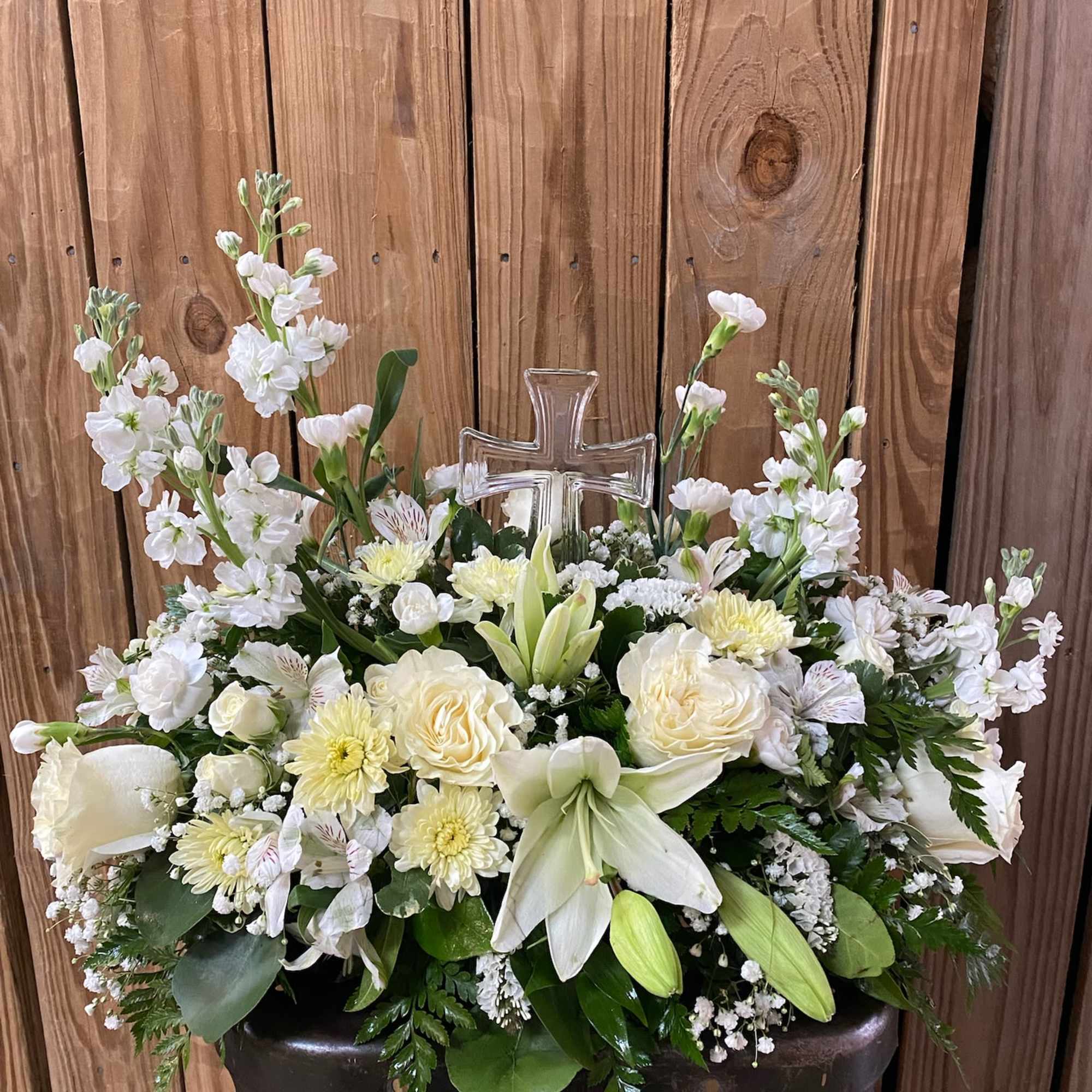 An elegant display of faith and divine peace, this beautiful arrangement will