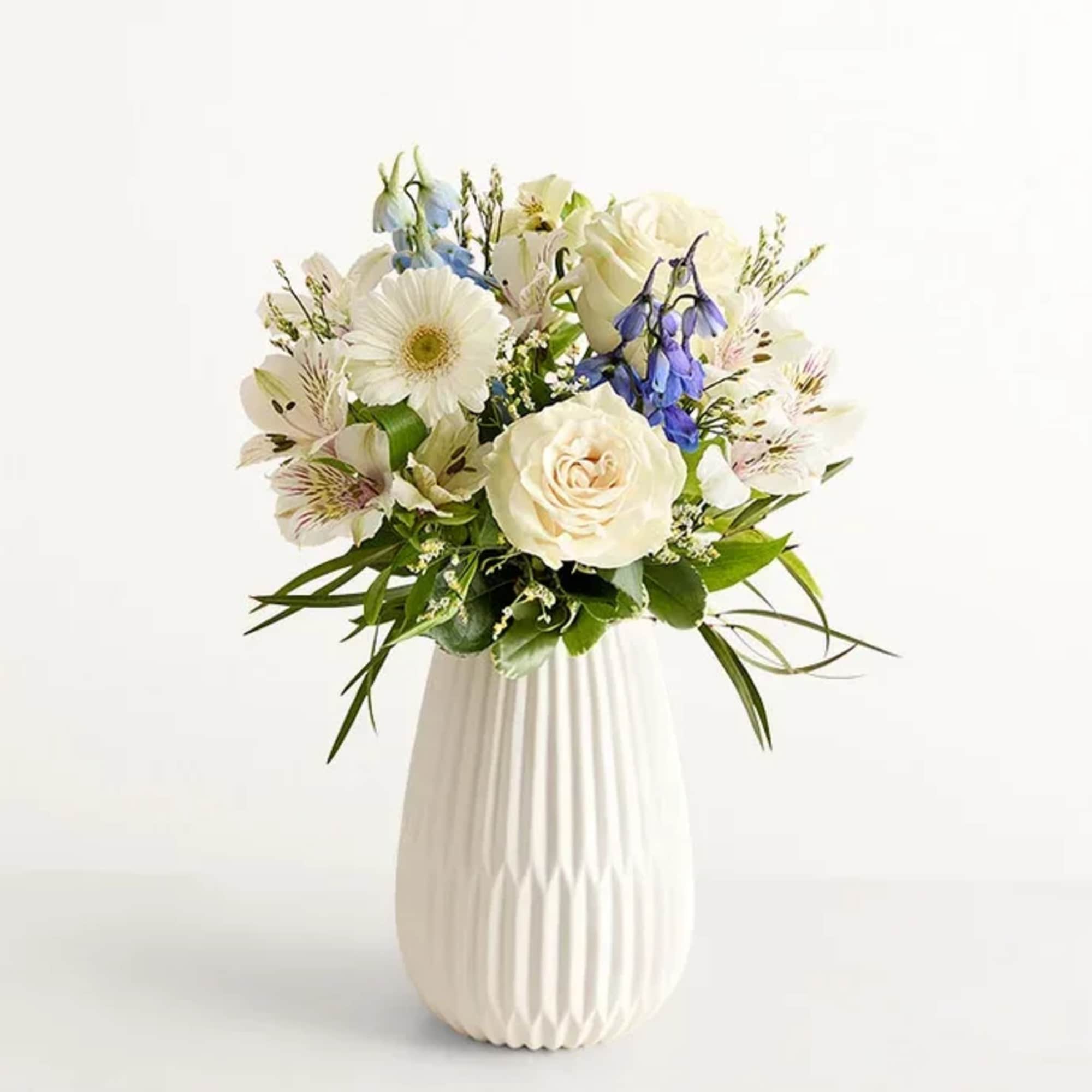 Send the calming beauty of winter in a bouquet. Hand designed by