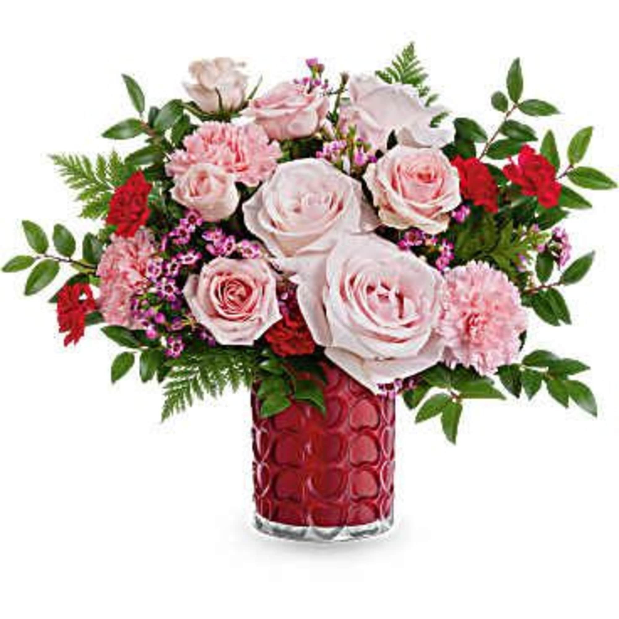 Pink roses and carnations in a red glass vase