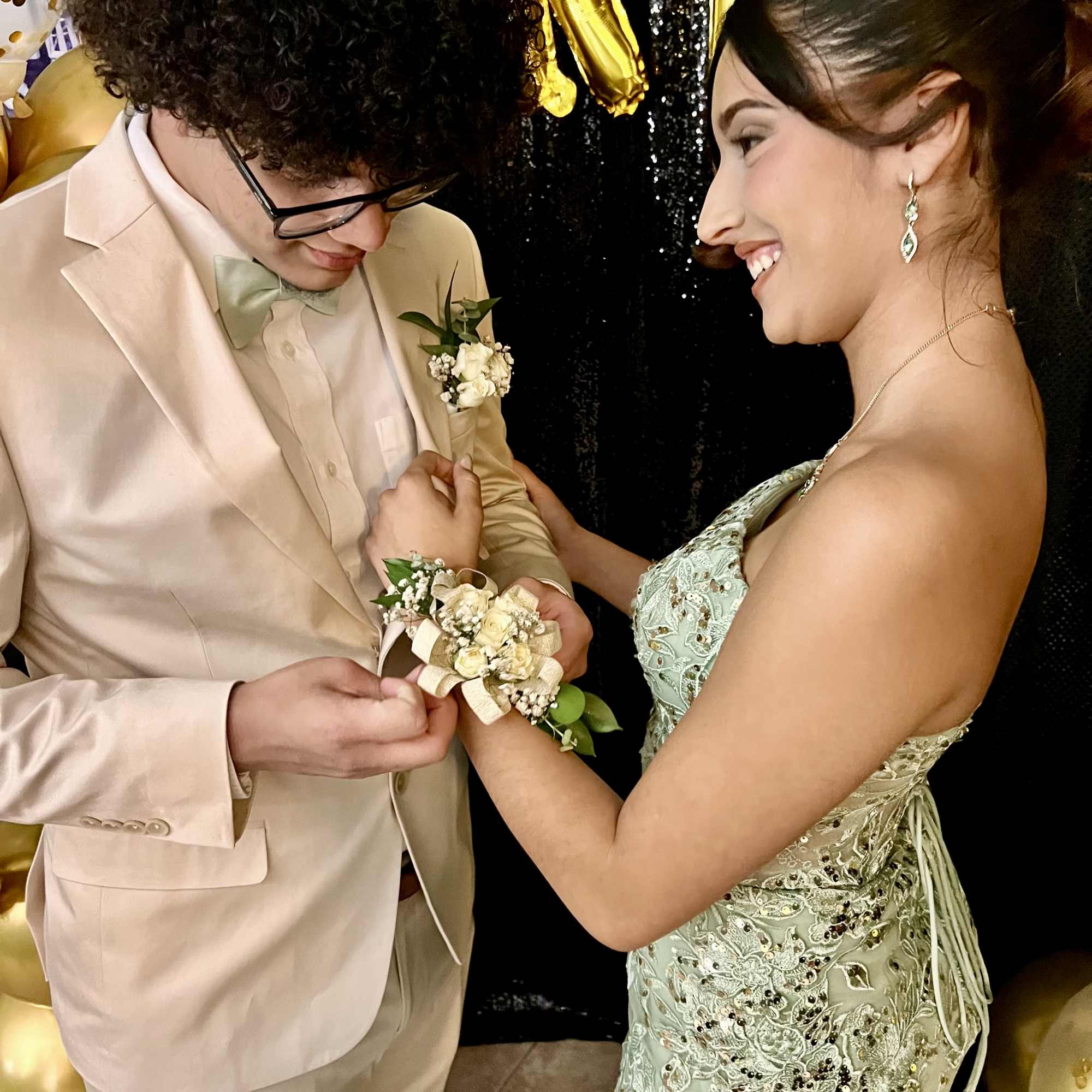 Young couple at a formal event with a boutonniere and corsage