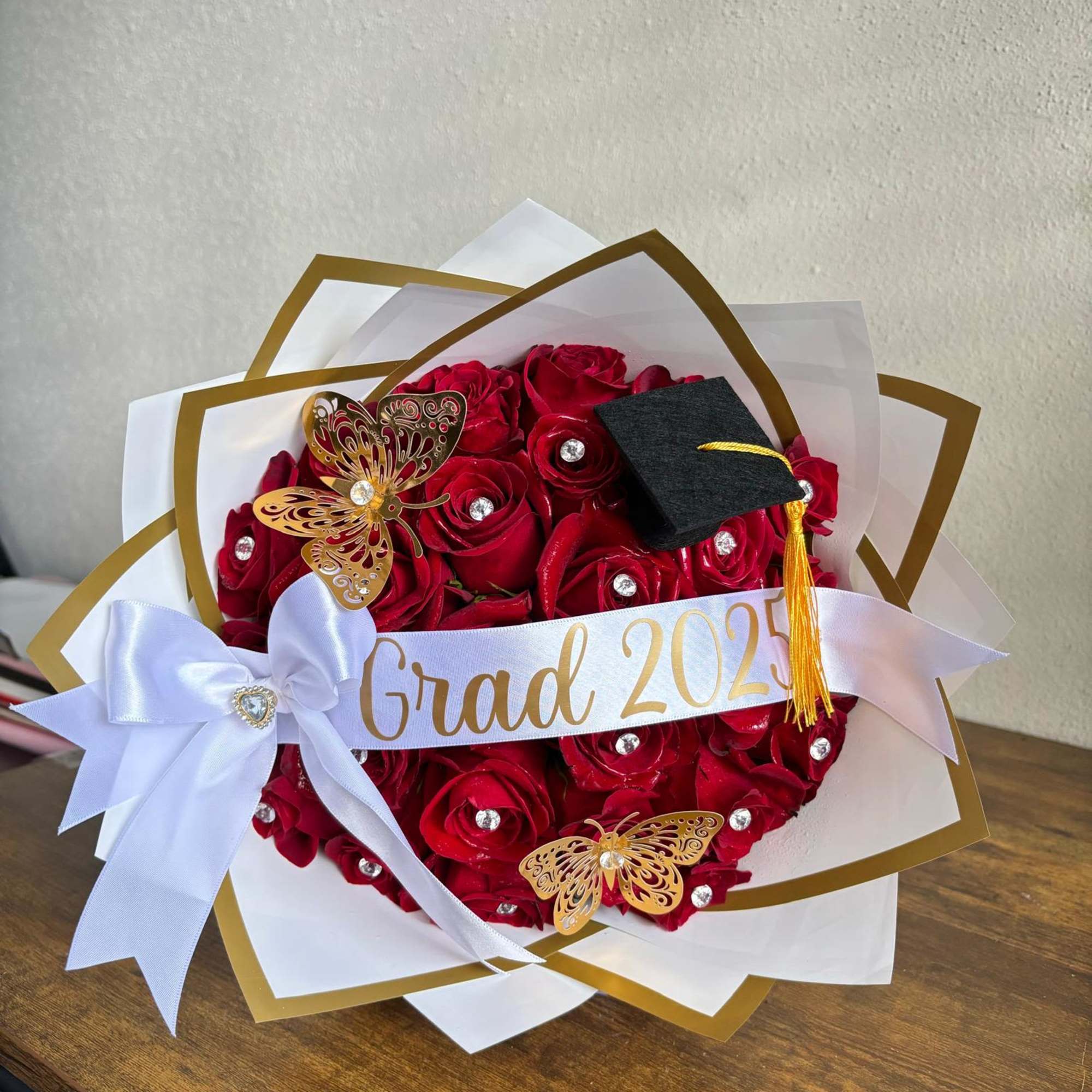 Red rose bouquet with a graduation cap and ribbon