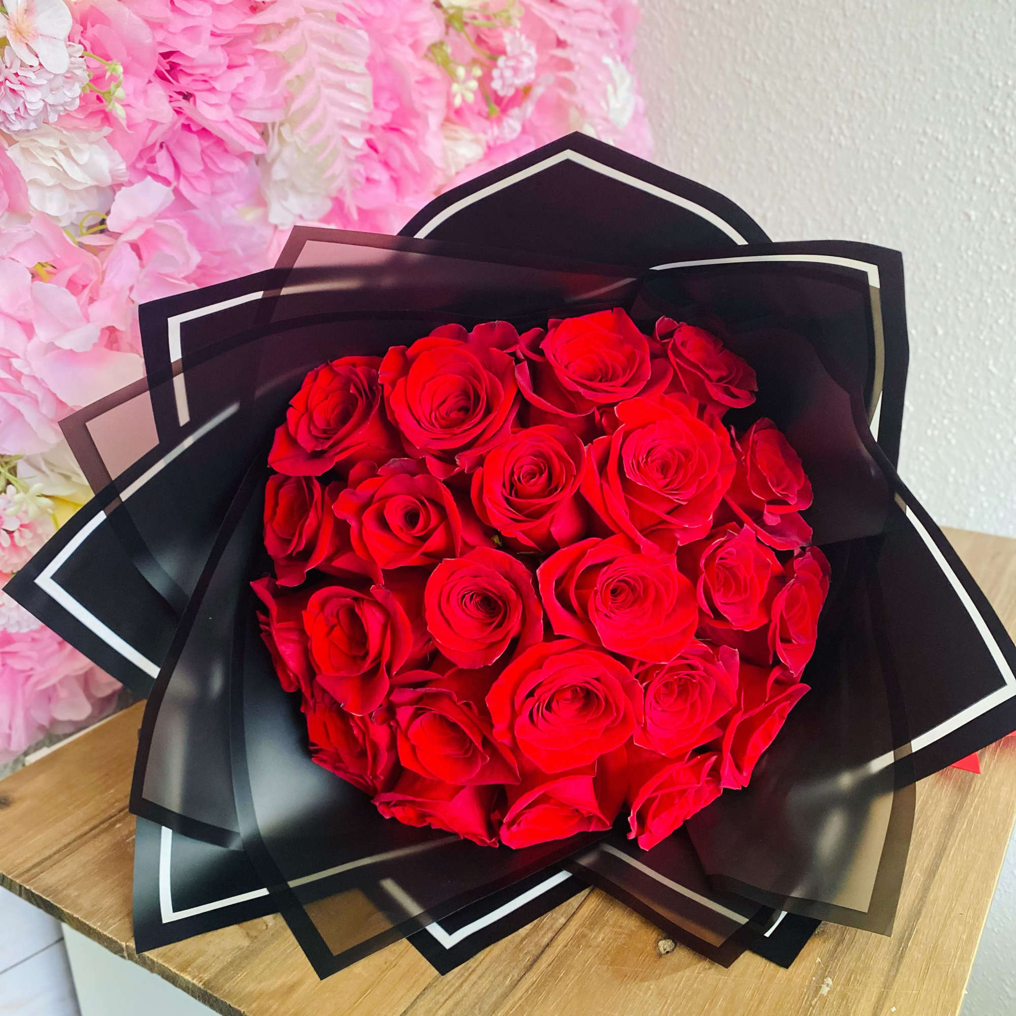 Bouquet of red roses wrapped in black paper