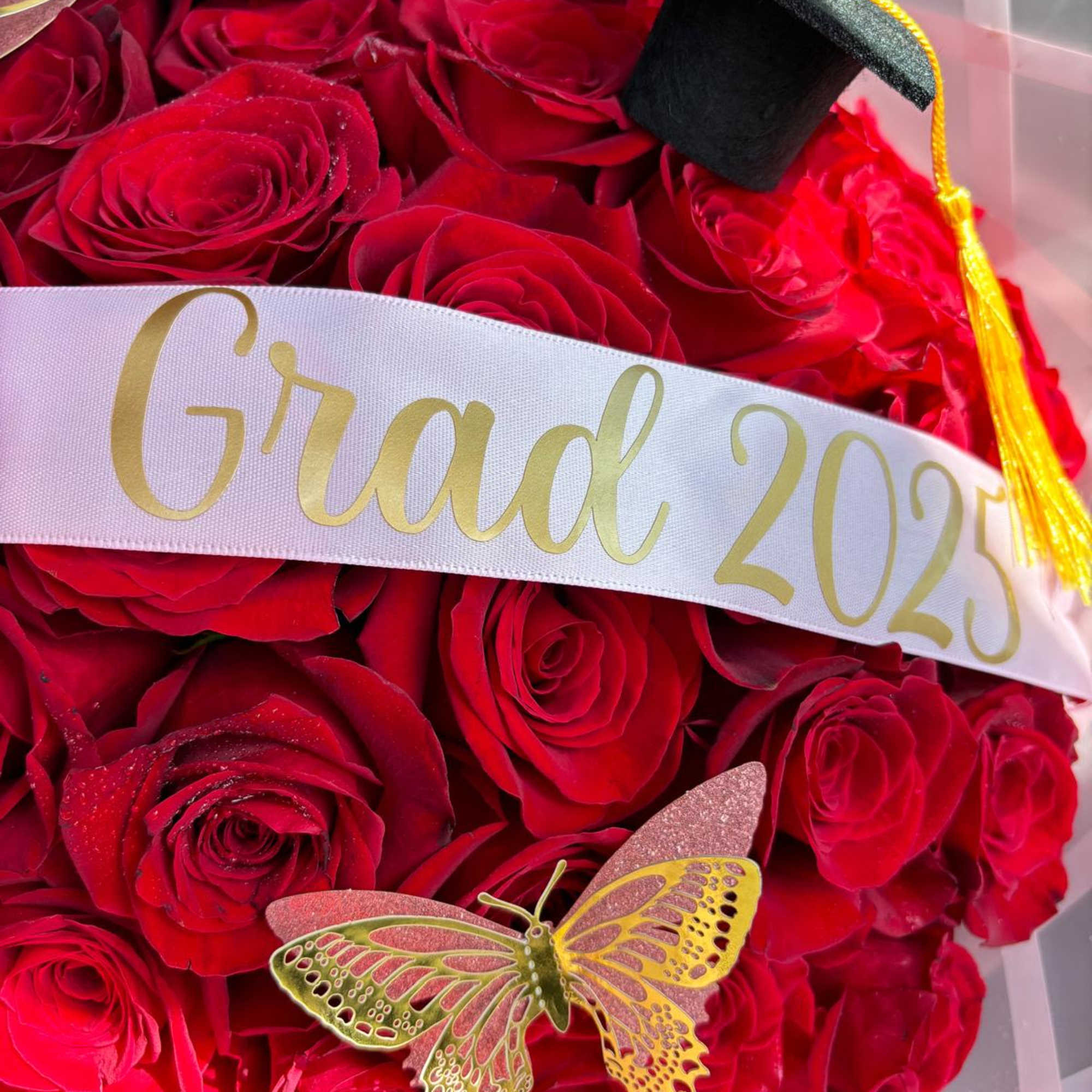 Red rose bouquet with a graduation sash and cap decoration