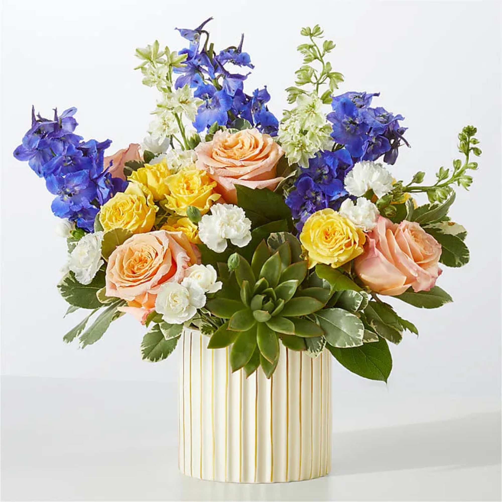 Get swept away by this daydream of a bouquet, arranged with peachy