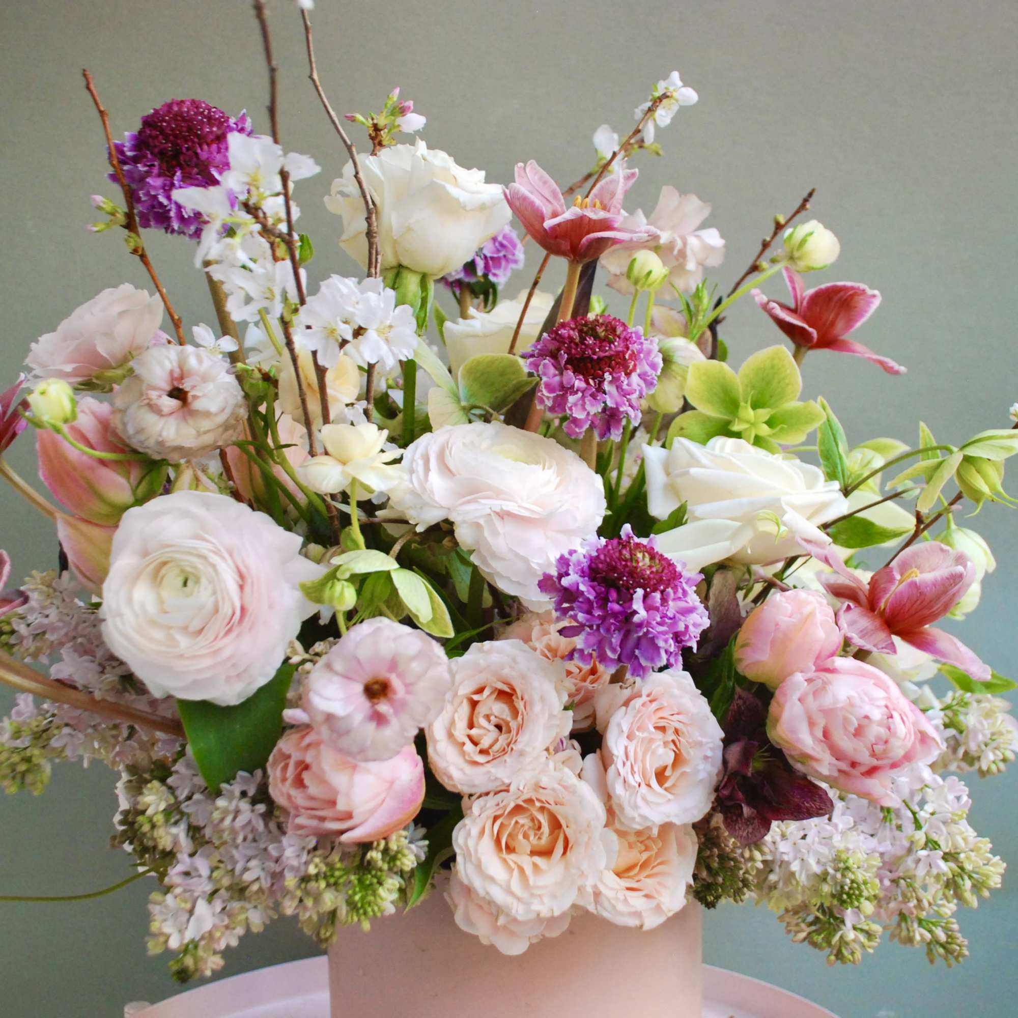 A soft pastel garden bouquet in blush pinks, creamy whites, lavender and