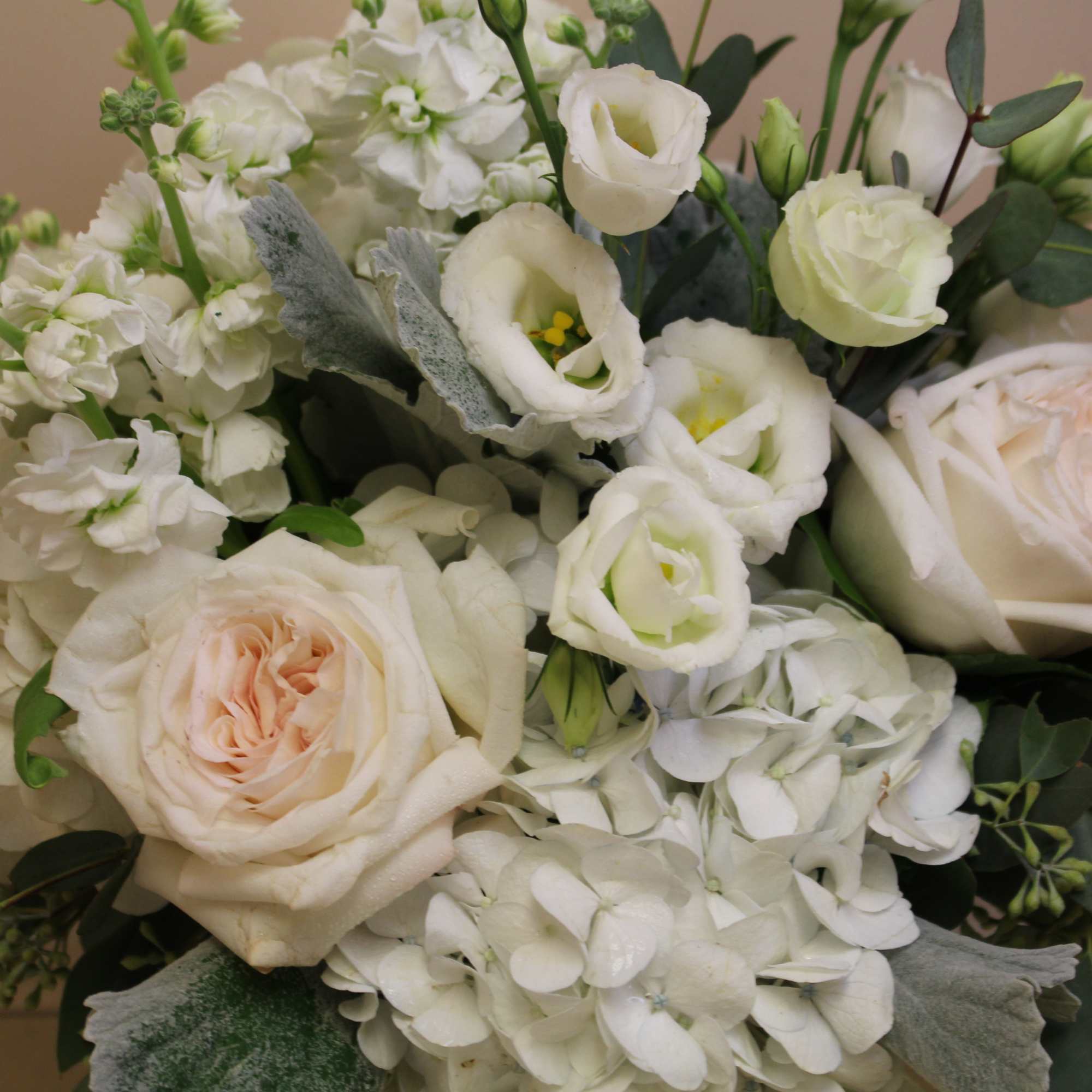 White and blush bouquet with roses, lisianthus, and hydrangeas