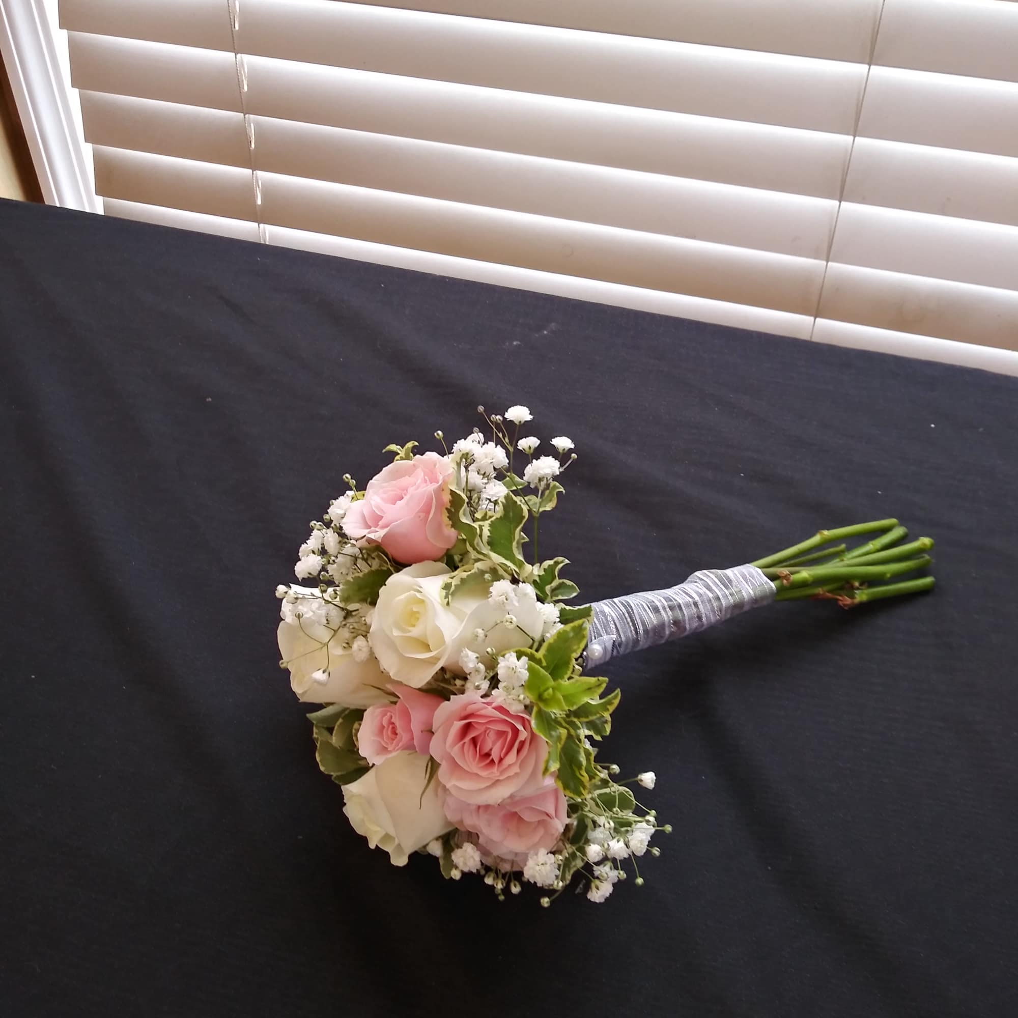 Small bouquet of pink and white roses with baby's breath